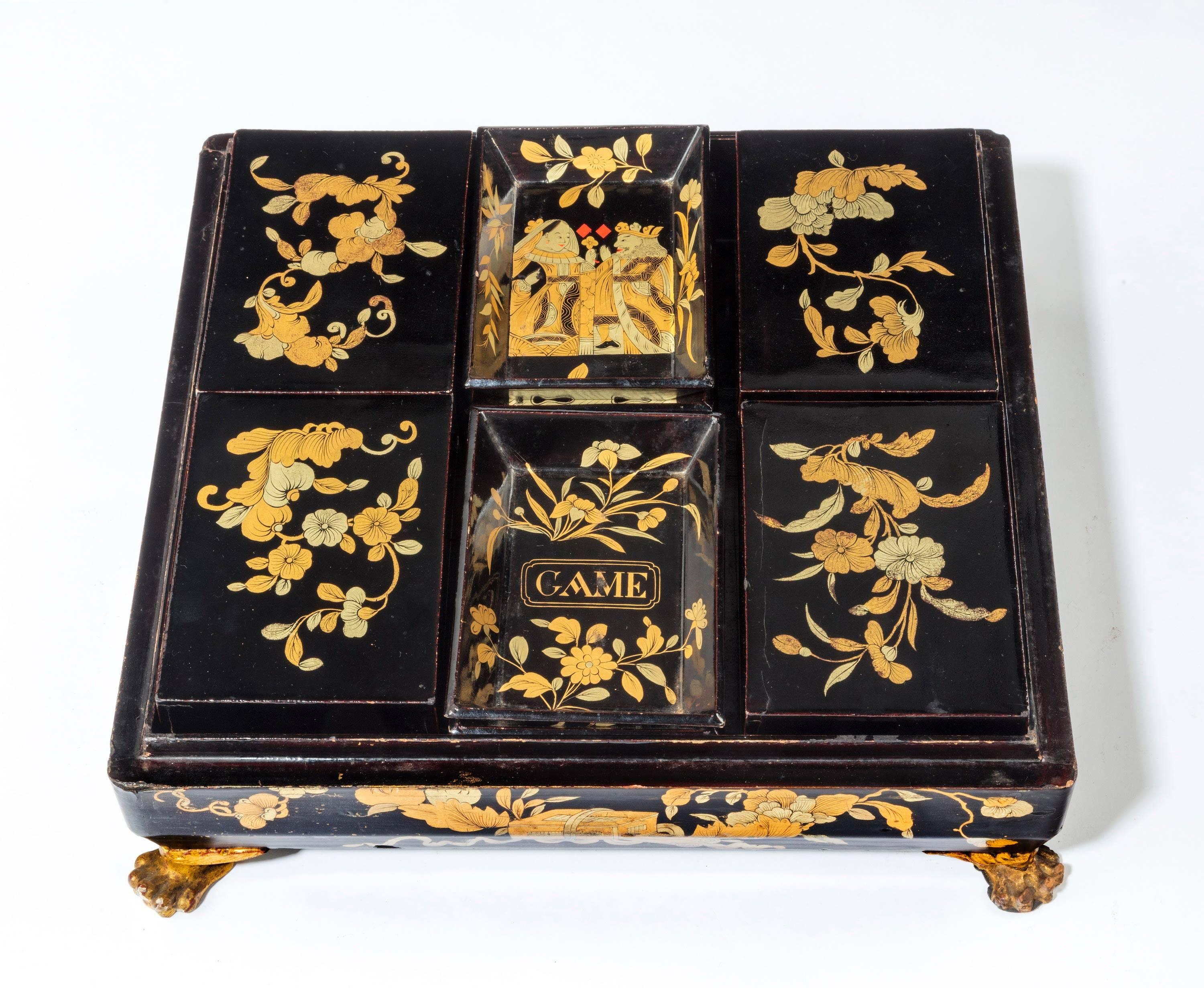 A good Chinese lacquered games box. The interior retaining the original fitted compartment. On four original, gilded metal feet. Excellent overall unrubbed condition.