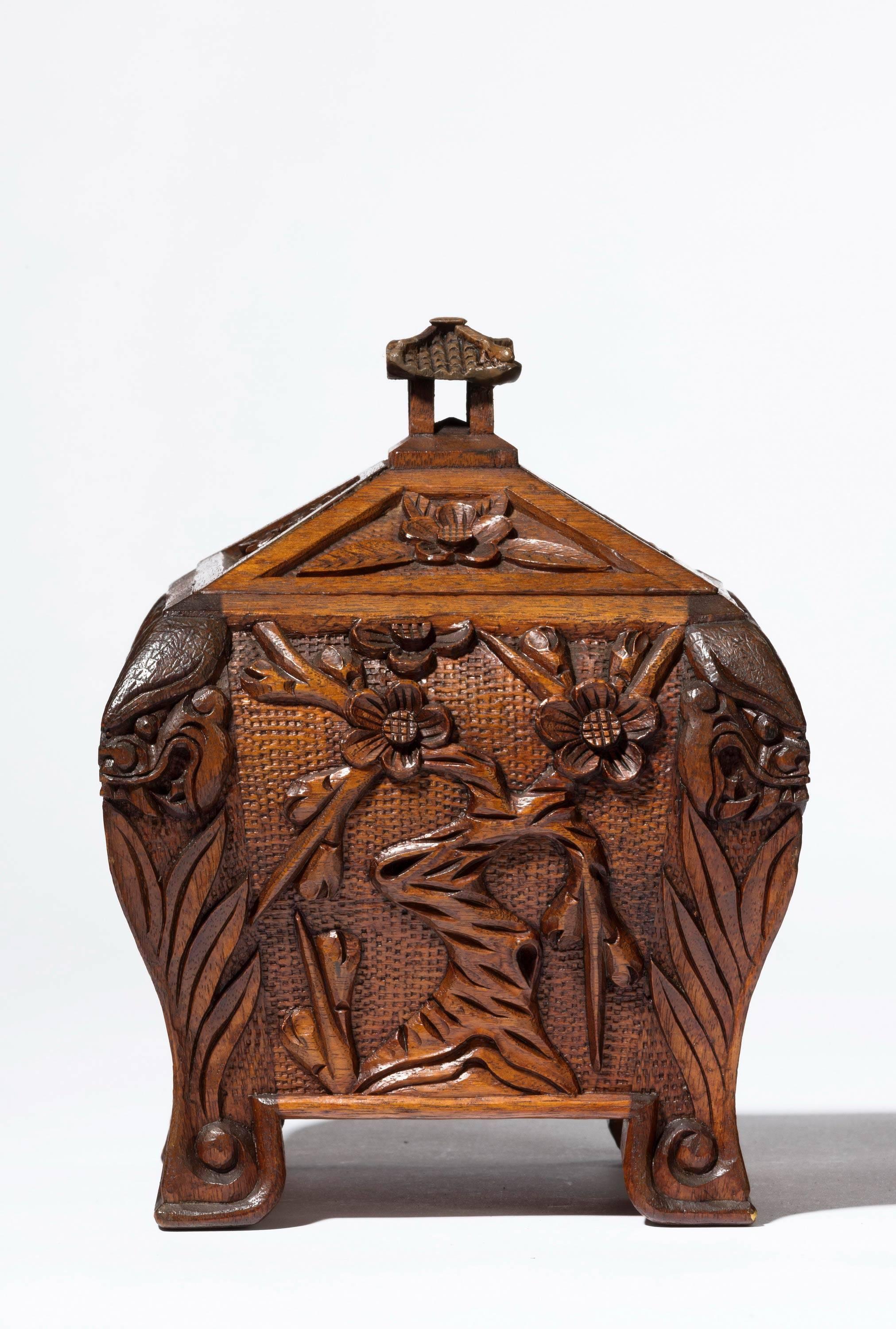 A Chinese wooden tea caddy retaining the original pewter lining. Exaggerated shape.