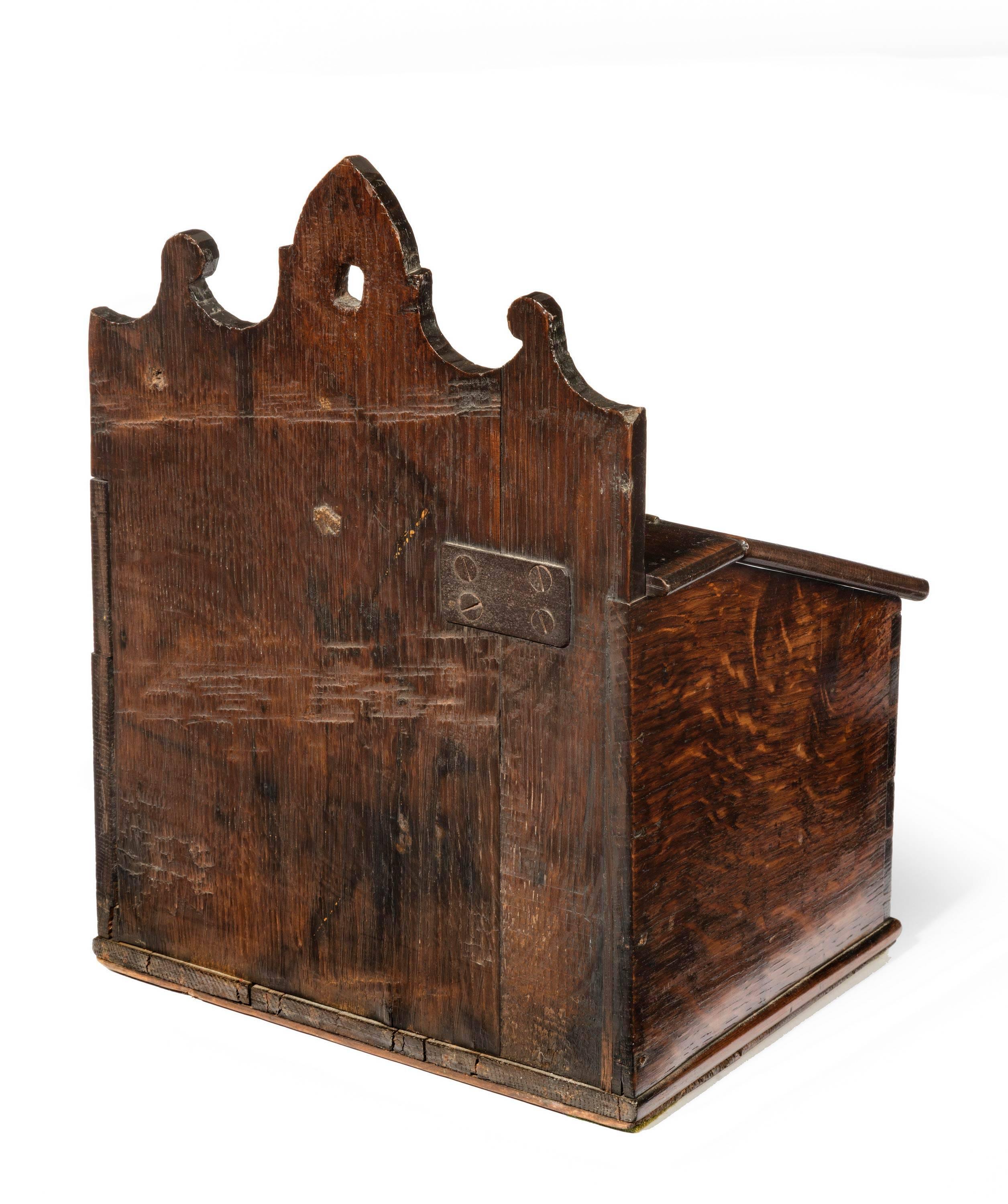 A good mid-18th century oak salt box with a shaped hanging arrangement. Excellent overall condition including the original polish.