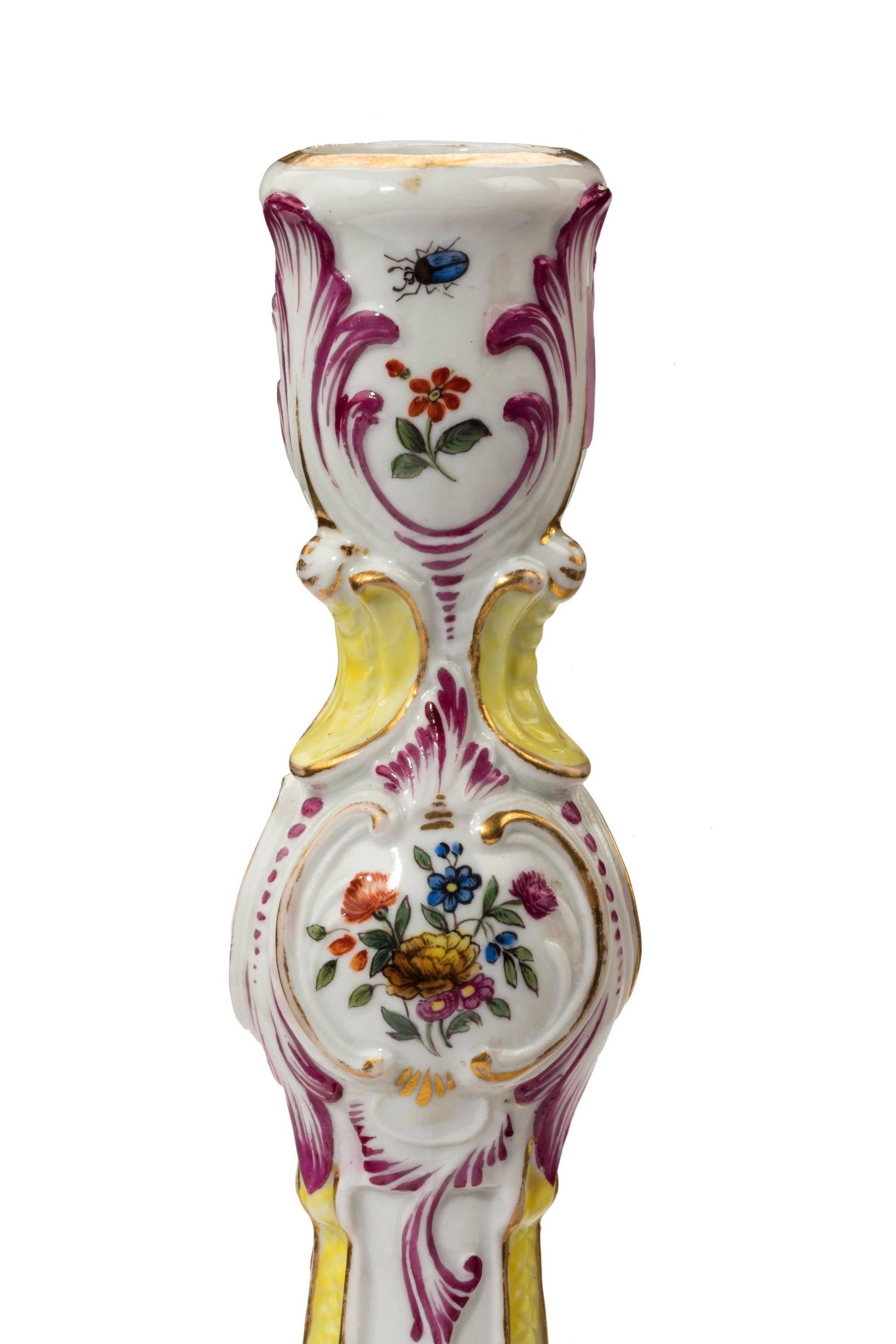 A good pair of Meissen porcelain shaped candlesticks with cartouche panels of figures and floral reserves to the top section. Excellent overall condition.
