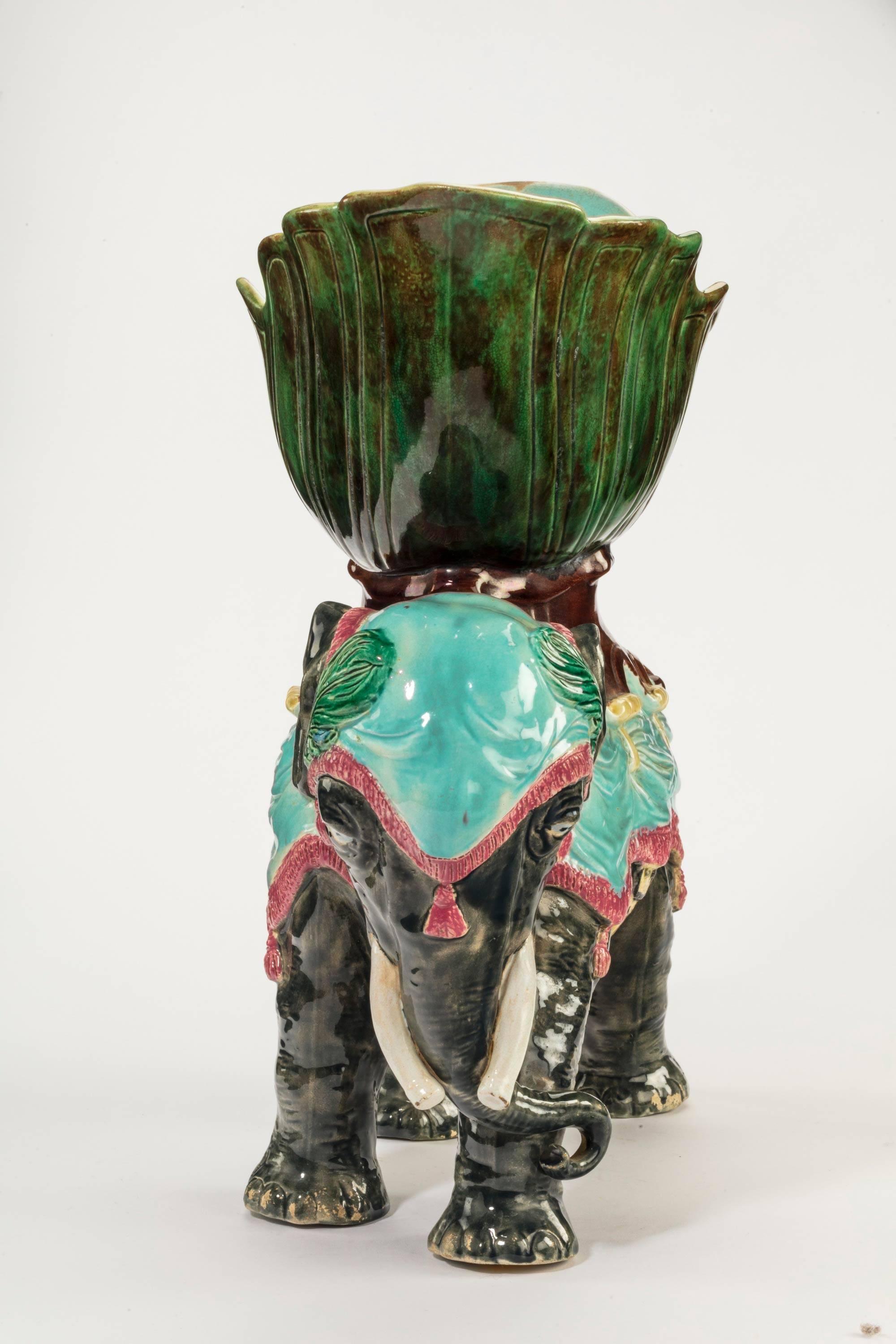 An unusual Majolica pottery elephant caparisoned with jardinière. Excellent overall condition.