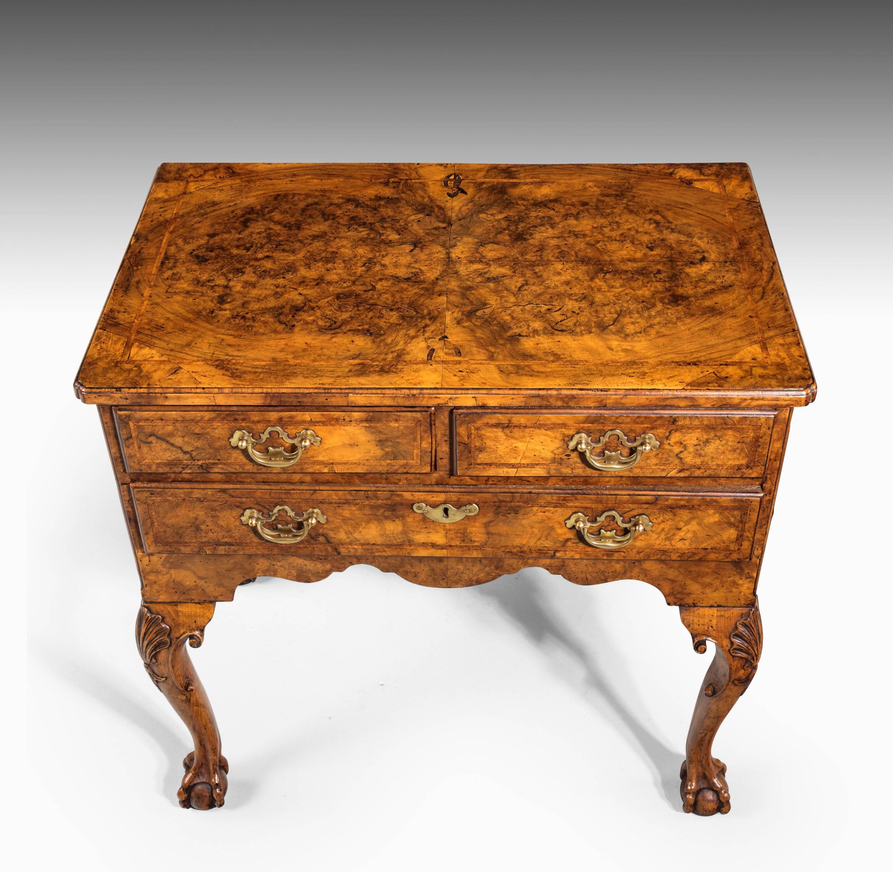 A near pair of George I period beautifully figured walnut lowboys. Well carved cabriole supports terminating in claw and ball feet. The knees with elaborate fans. Herringbone inlay on all sides.