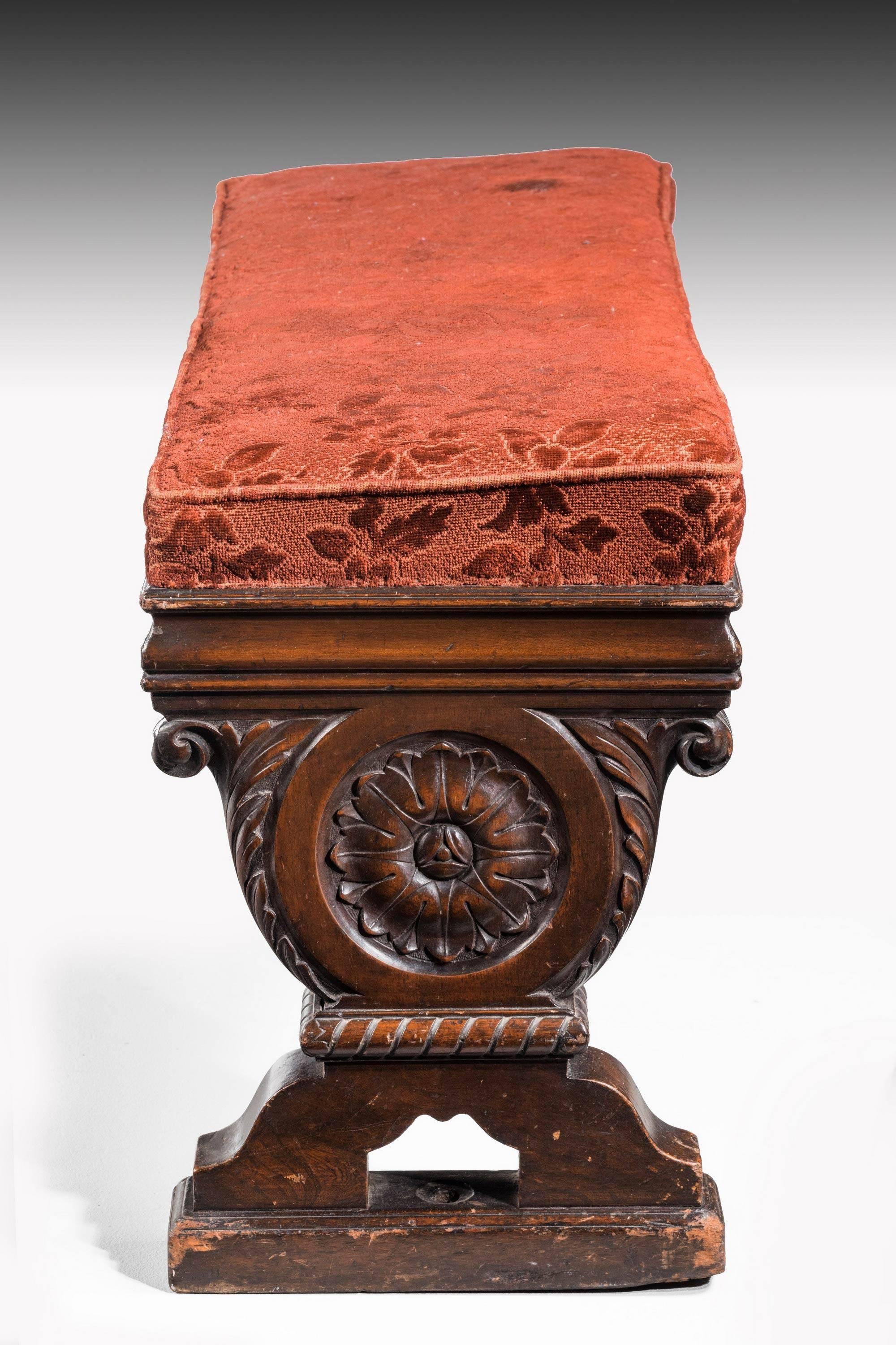 A mid-19th century carved mahogany and upholstered double stool. With finely carved lyre shaped ends. 

 