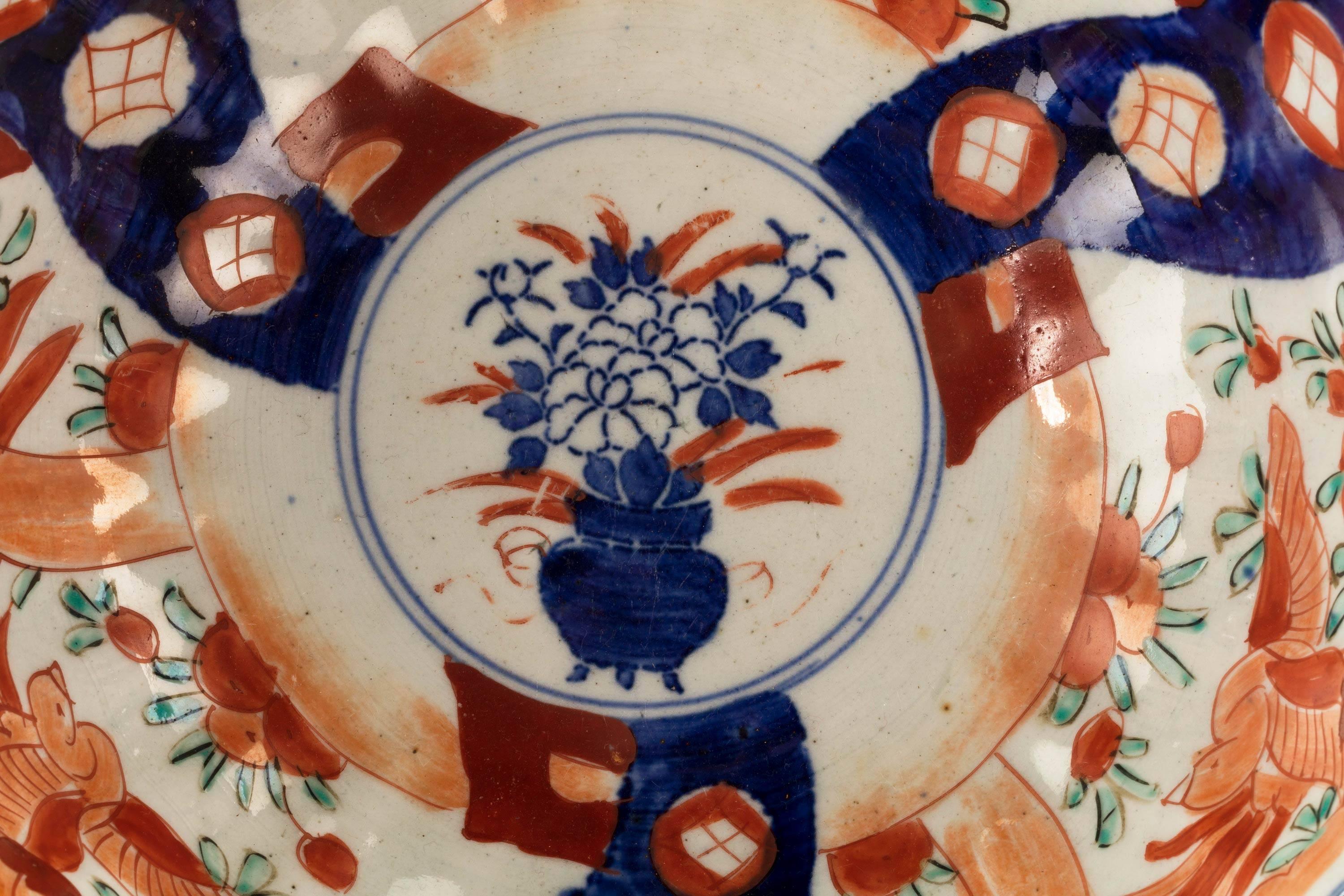 A mid-19th century Japanese pottery porcelain bowl. Typical blue, red and iron decoration.