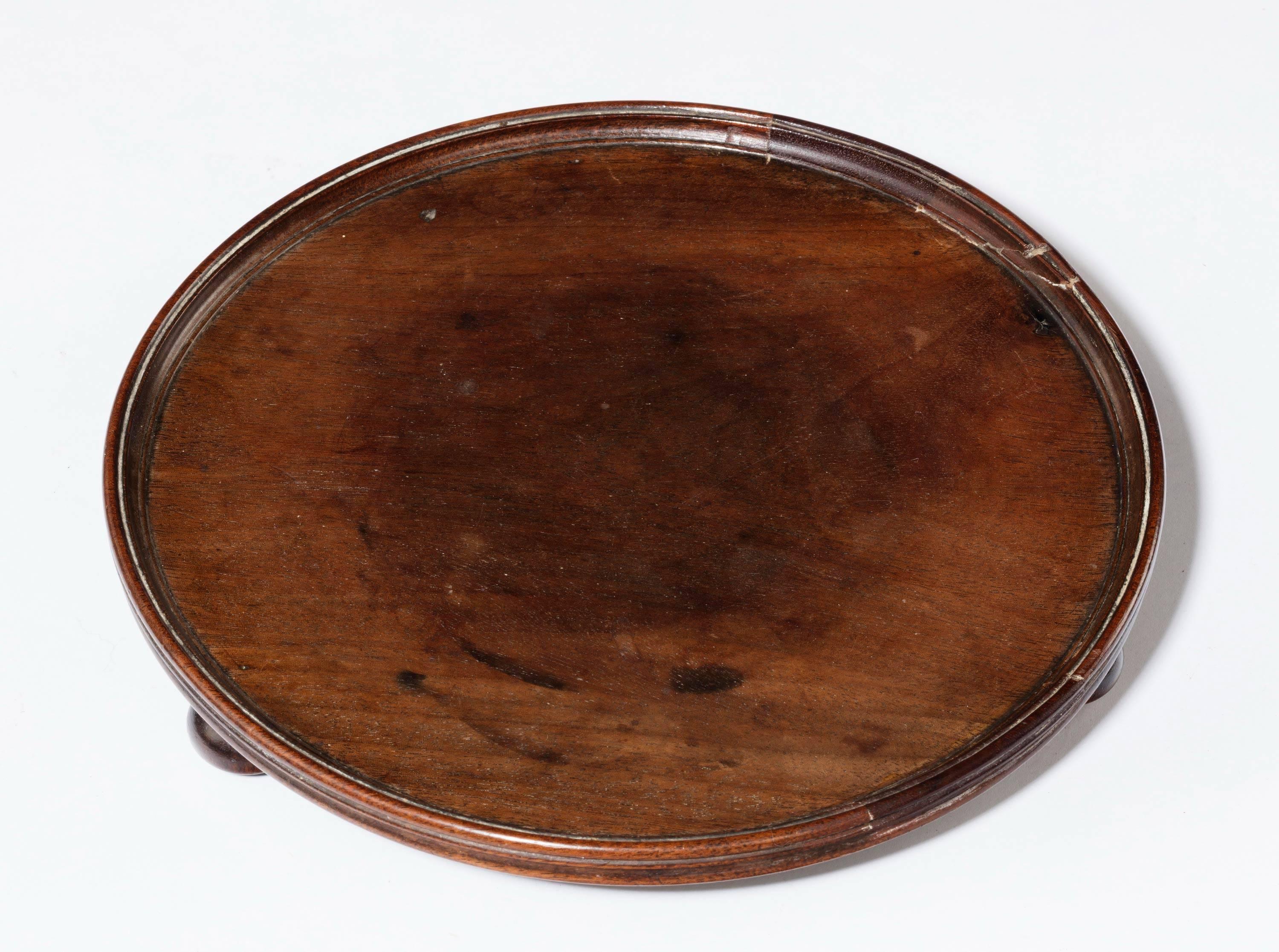 An attractive George III period mahogany card tray of circular form. With ribbed edge which has minor restorations.