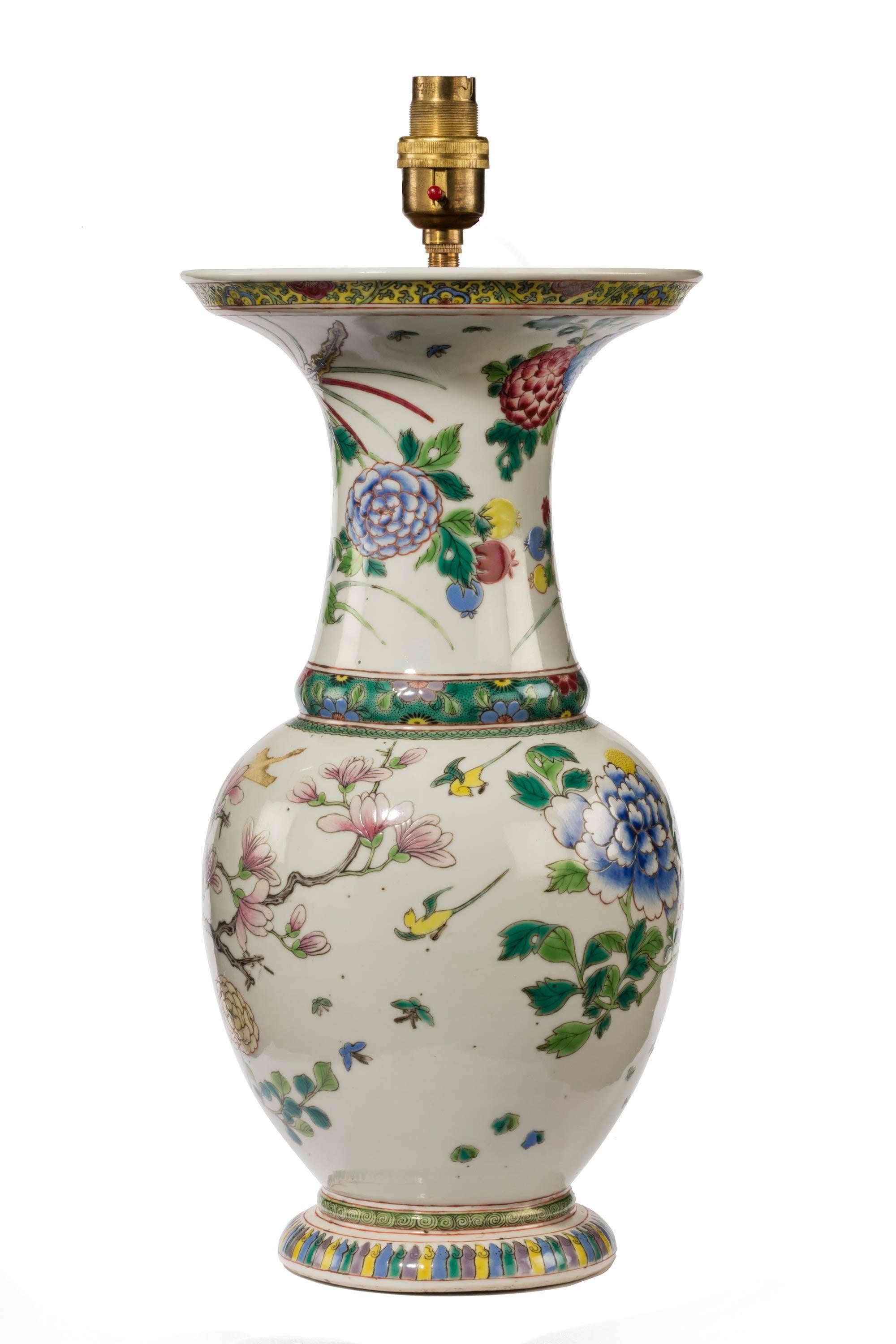 A shaped Chinese mid-20th century porcelain vase lamp with a flared top. Finely enamelled with chrysanthemums, pyrenes and foliage