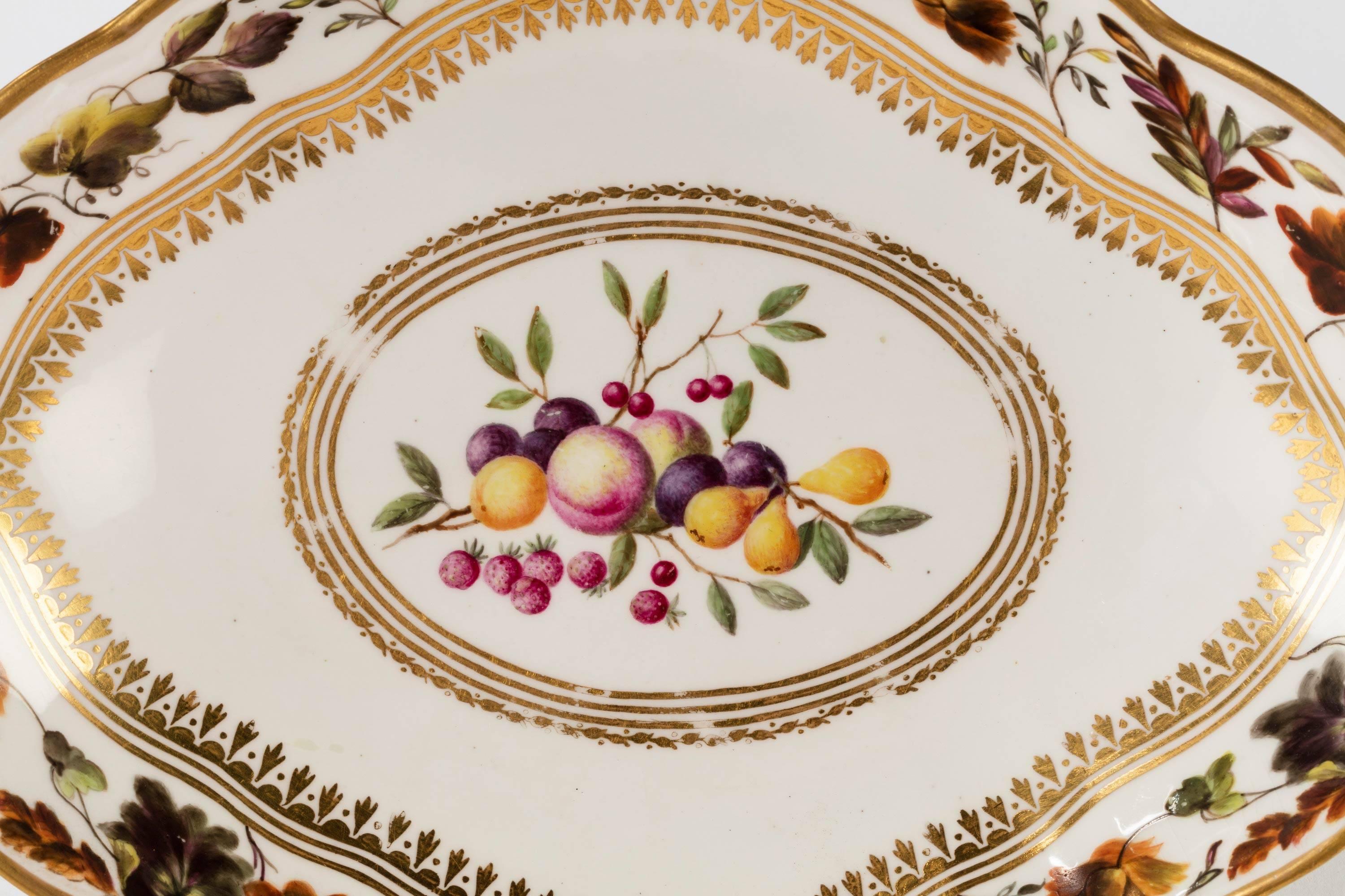A puce marked Derby shaped dish. Painted with fruits and a broad border with foliage and flowers.