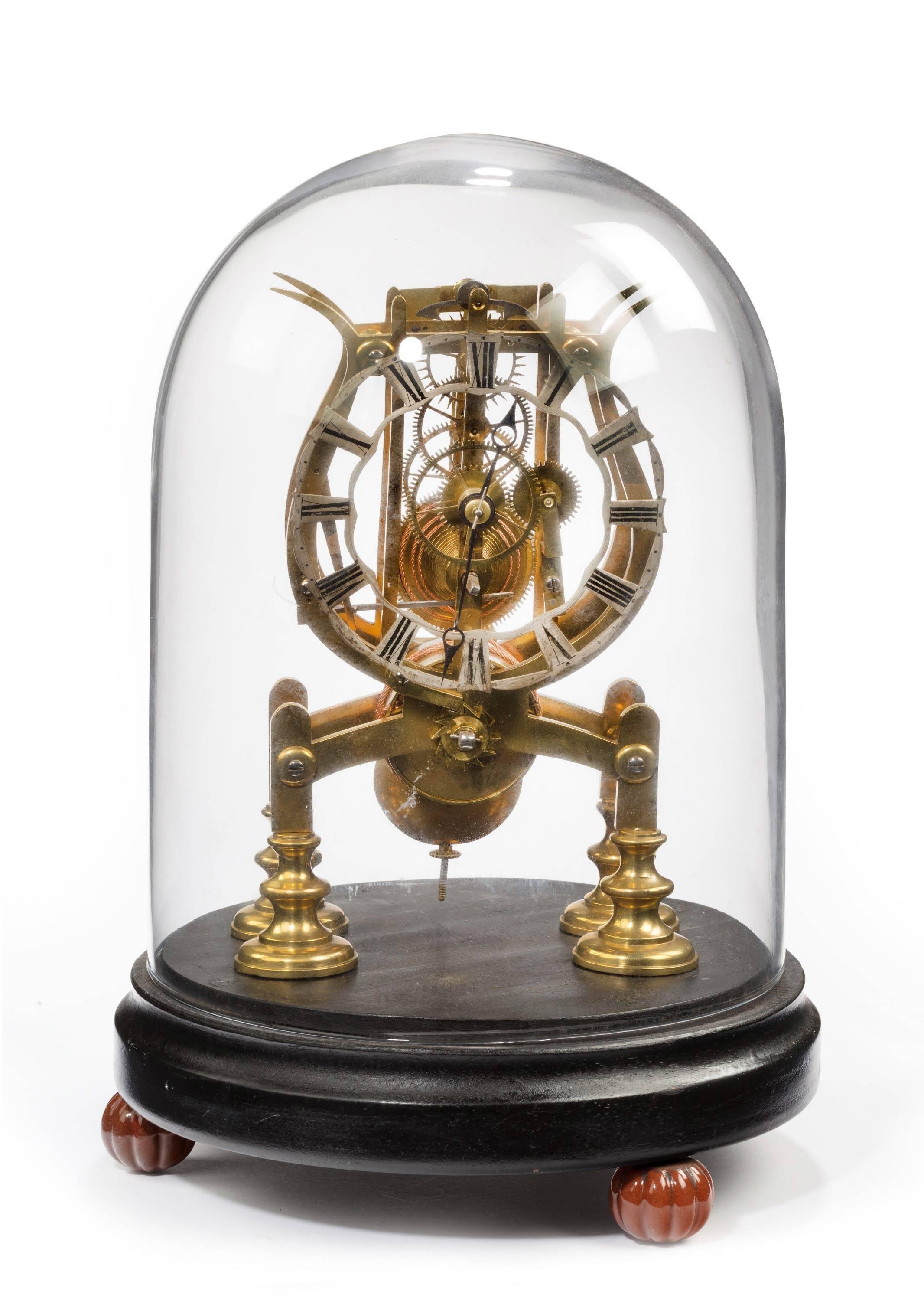 A late 19th century brass skeleton clock with silver dial.