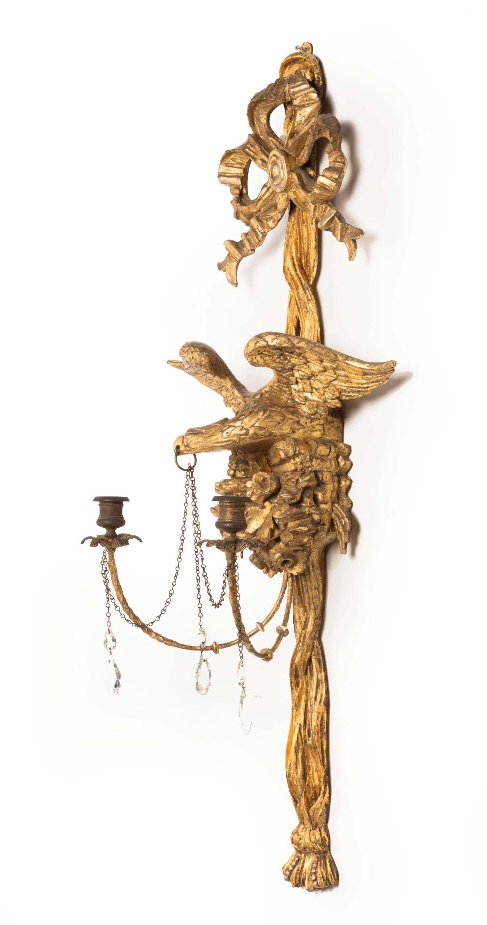 A pair of Regency period wall lights the eagle in-flight, in gilt bronze. Original candle sconces now heavily patinated. Gilding largely original with 19th century highlights.
