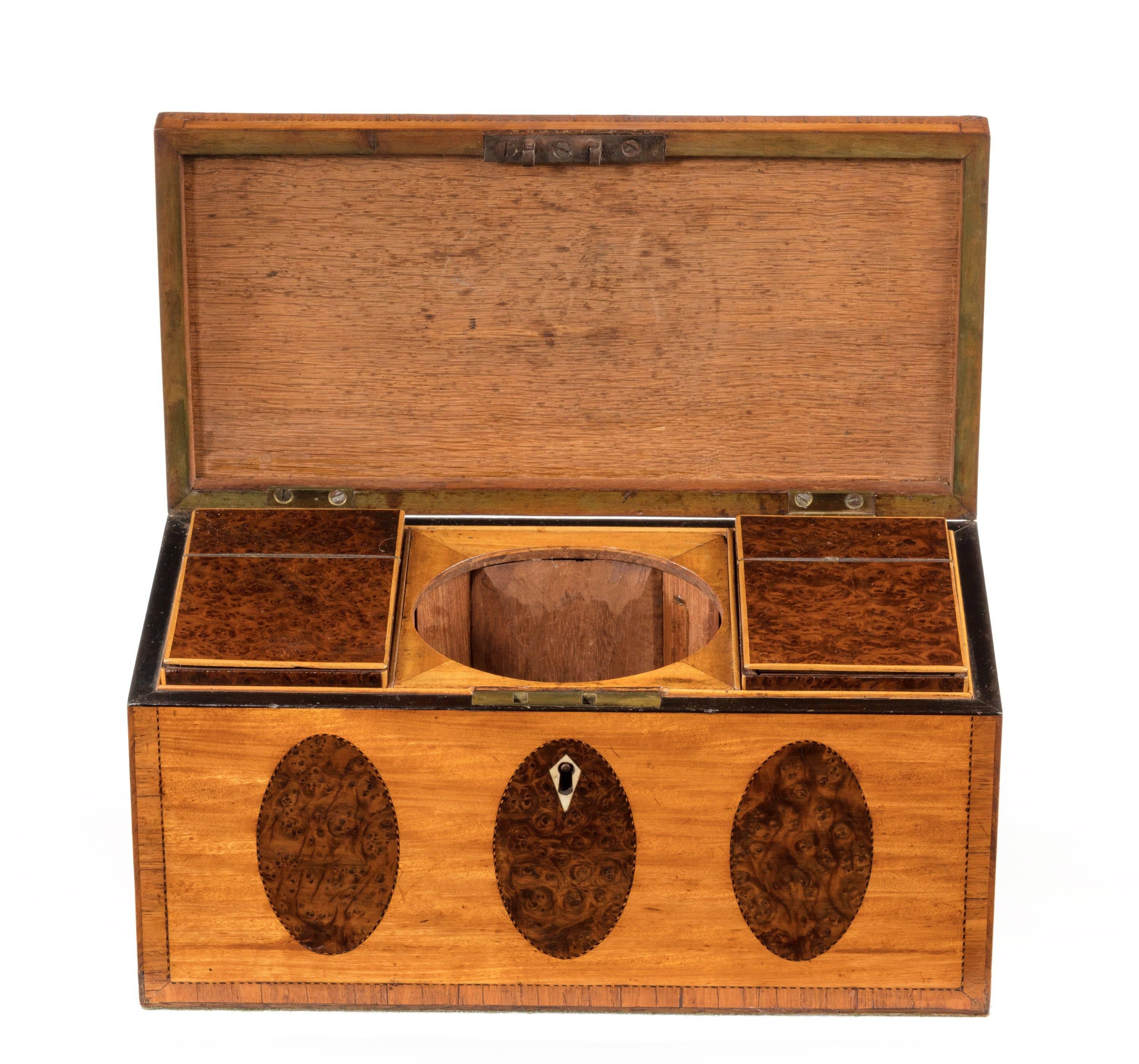 George III period Satinwood and burr yew tea caddy. Of quite exceptional quality. The interior with two original lidded burr yew containers. The central mixing bowl now missing.