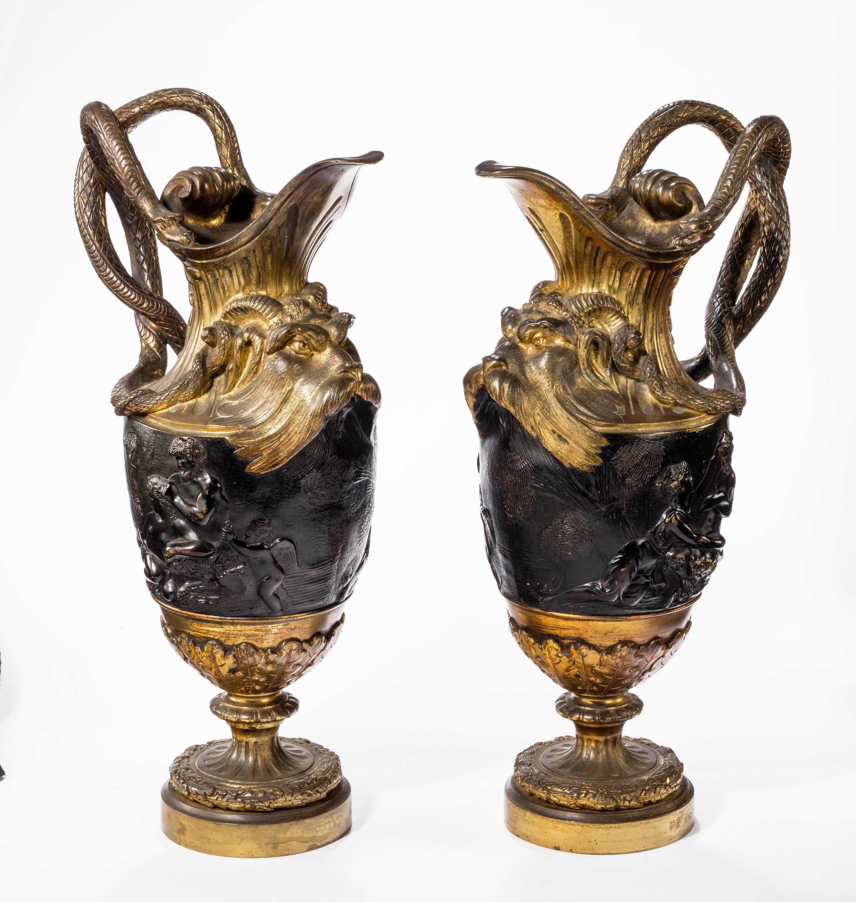 A fine pair of bronze and gilt bronze ewers in the manner of Clodion. Original patina now somewhat naturally discolored. Very fine modelling which is very reminiscent of Flaxman. 

Claude Michel (December 20, 1738 – March 29, 1814), known as