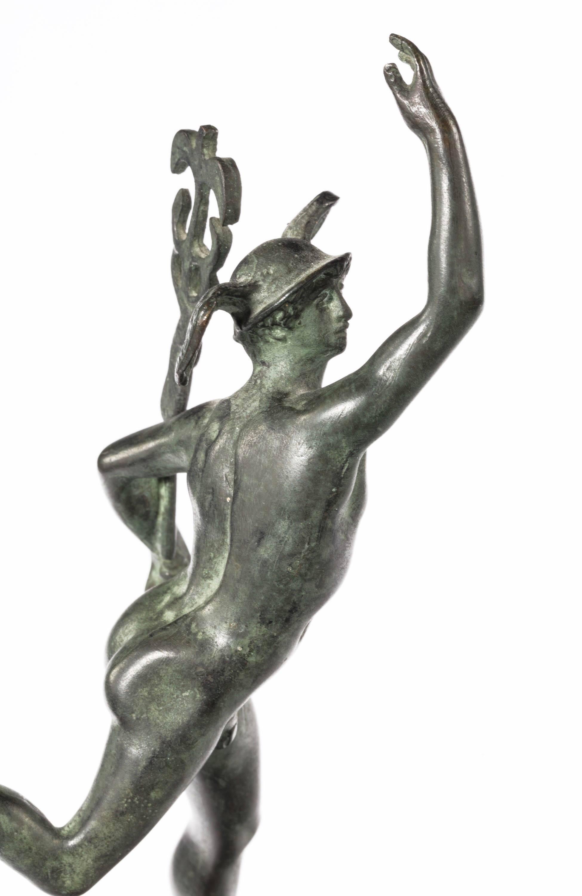 A early 19th century dark green patinated Grand Tour figure of Mercury. On the original marble base.