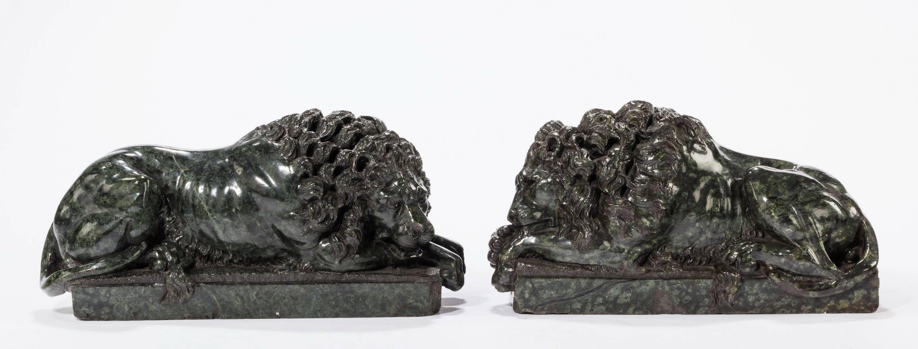 A finely modelled pair of serpentine desk lions after the models by Conover. Excellent overall condition and showing age patina.
