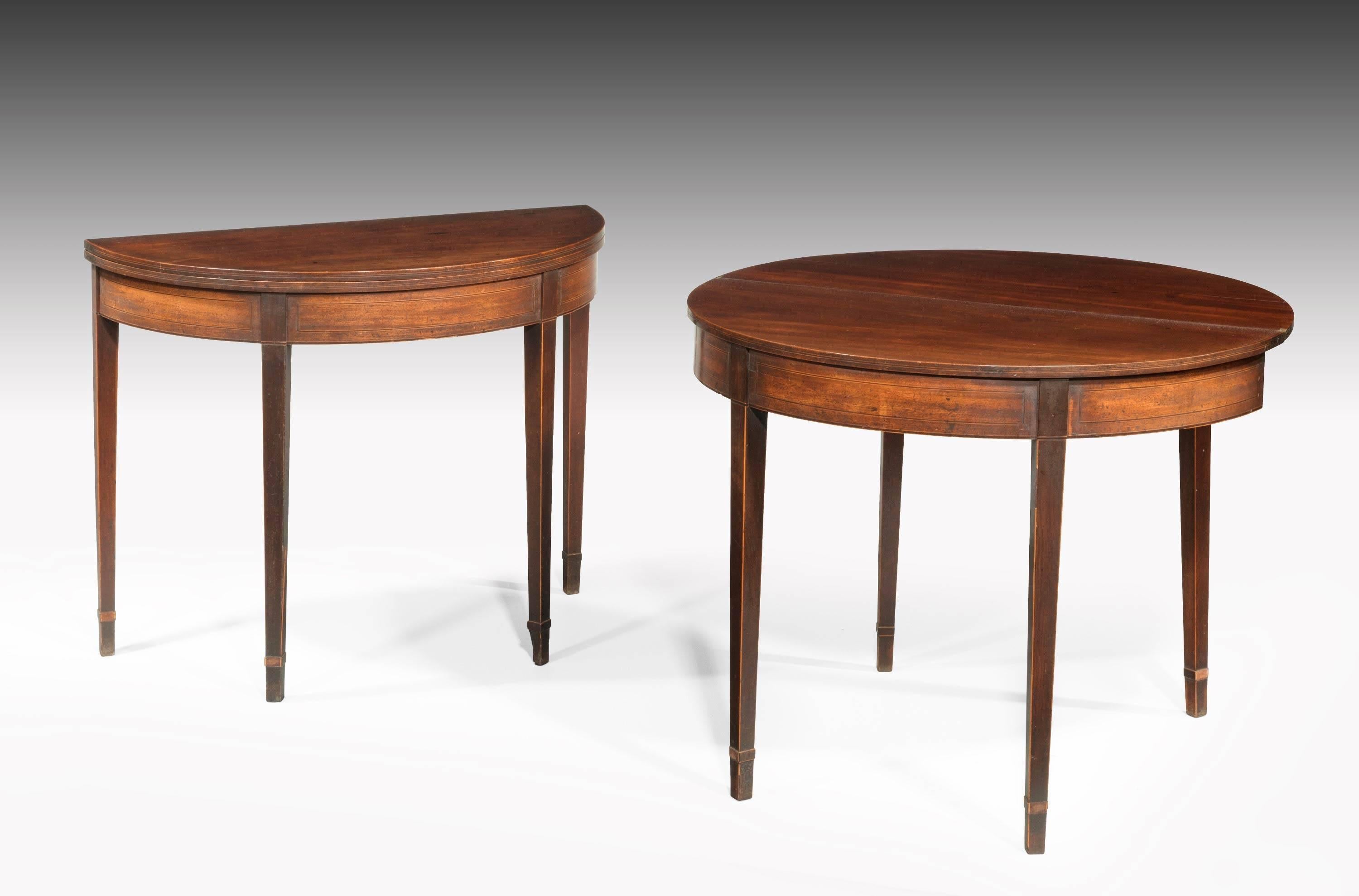 A good and original pair of George III period mahogany demilune card tables. On square tapering supports with banded shoe feet. Fine line inlay to the top and bow front sections. 

When open the width is 35 inches.