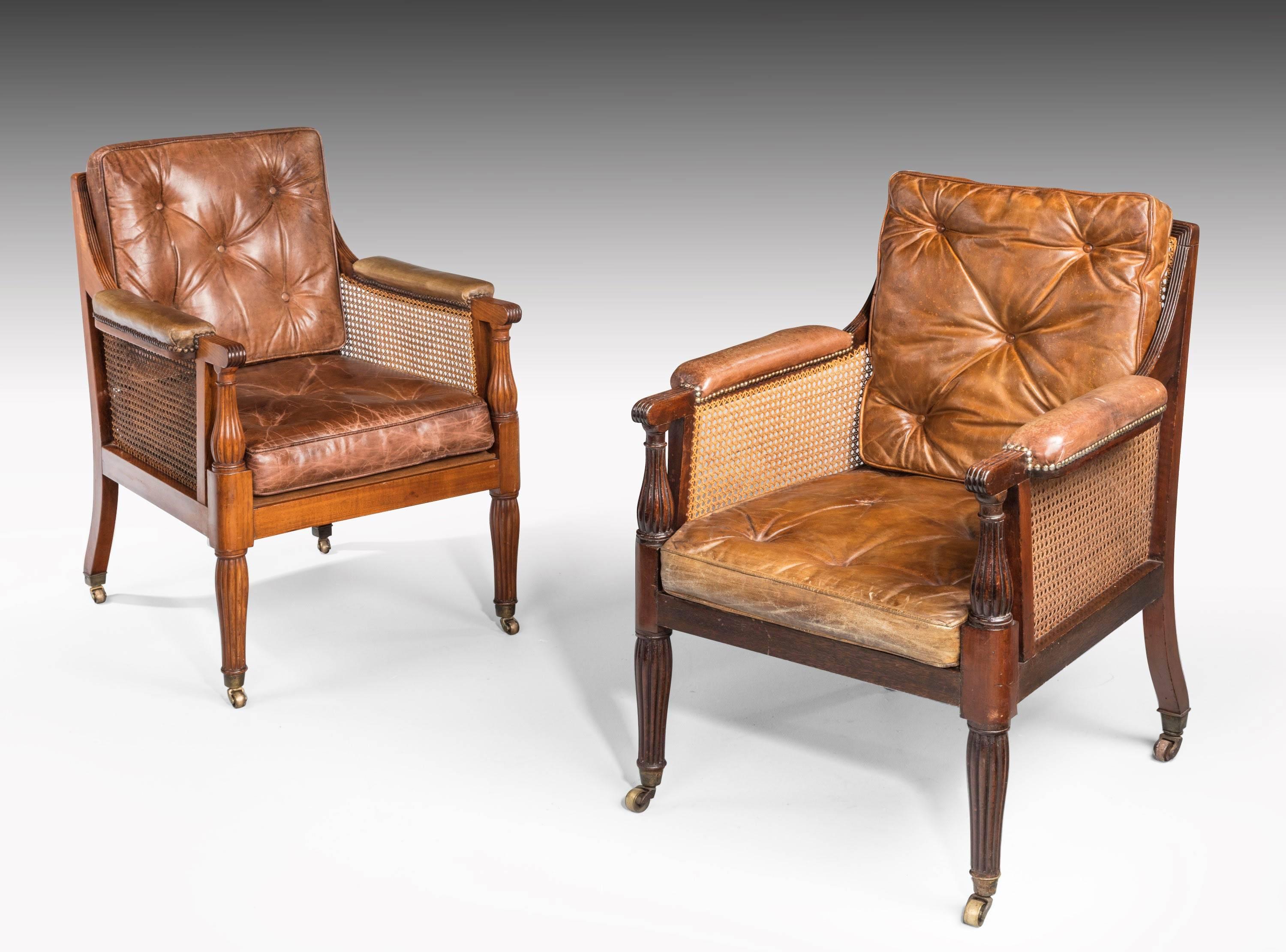A exceptionally fine and original pair of Regency period bergere armchairs. Retaining the original canework. Of generous size. Totally unrestored condition including the polish.