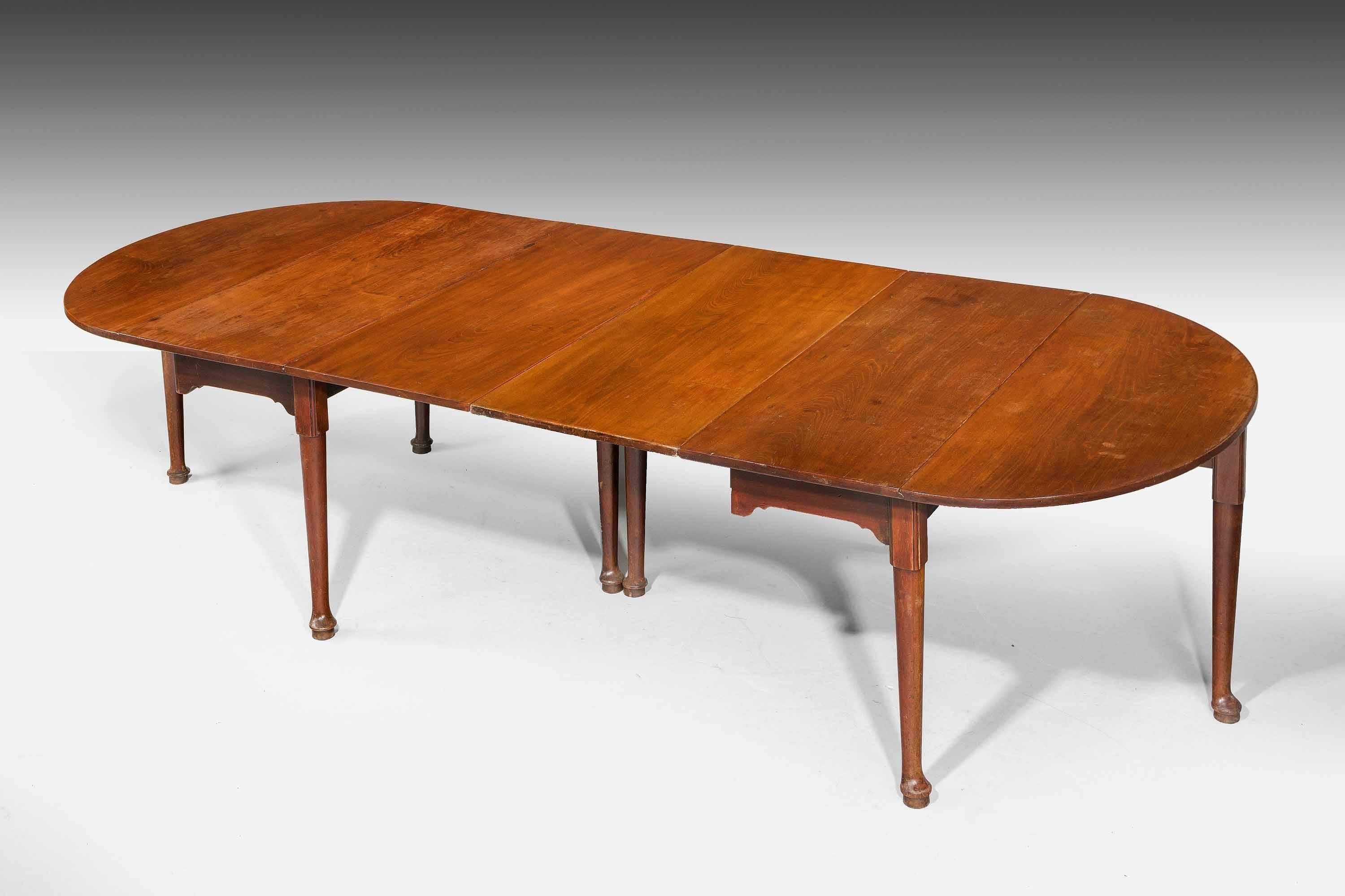 A rare early George III period mahogany dining table, the two end sections with removable leafs. demilune ends, the supports of gentle cabriole form terminating in pad feet. The timbers are beautifully figured and all are in their original