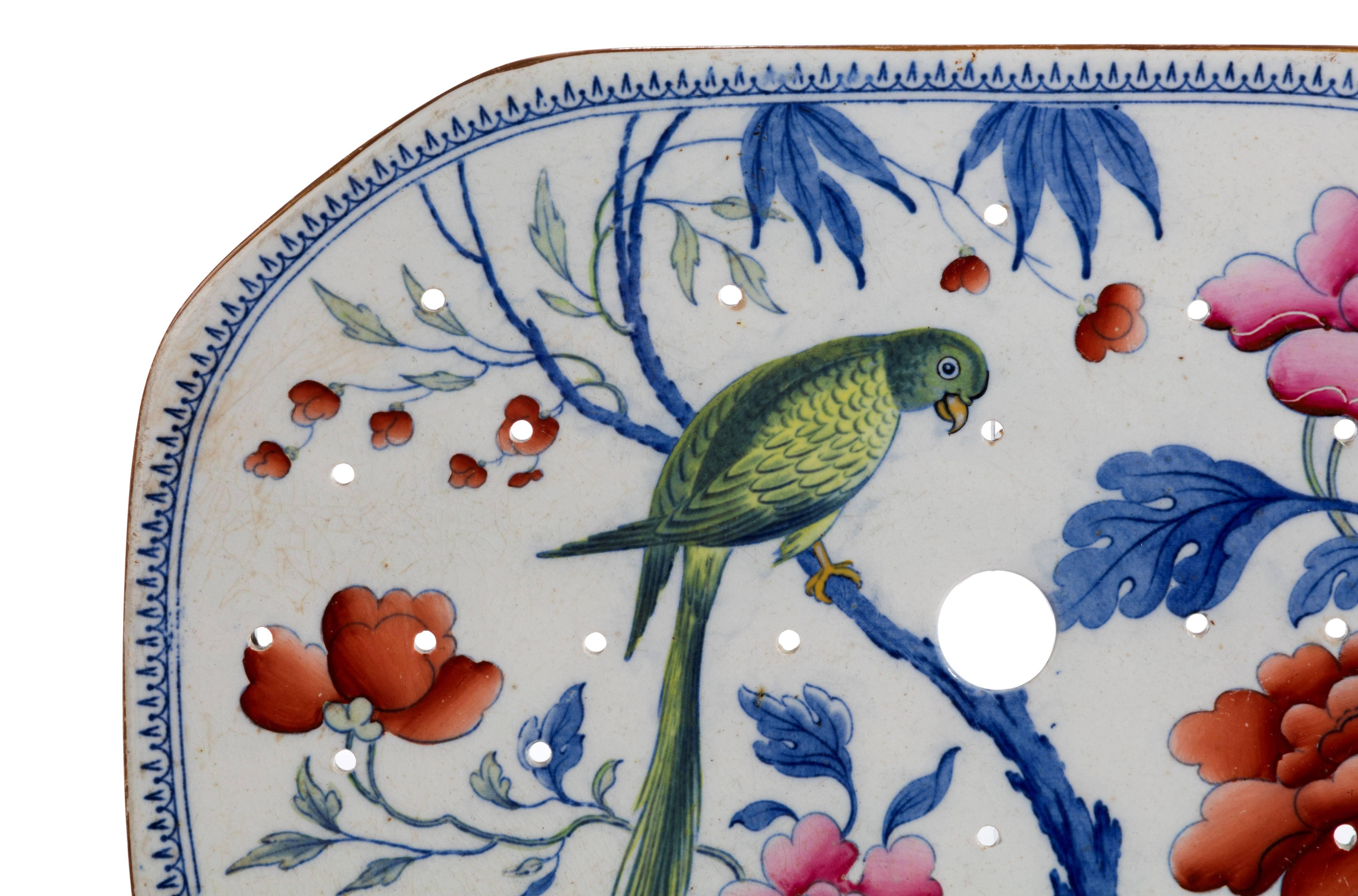 A stone China turkey drainer. Enameled with flowers and a parakeet. 

Excellent overall condition.
