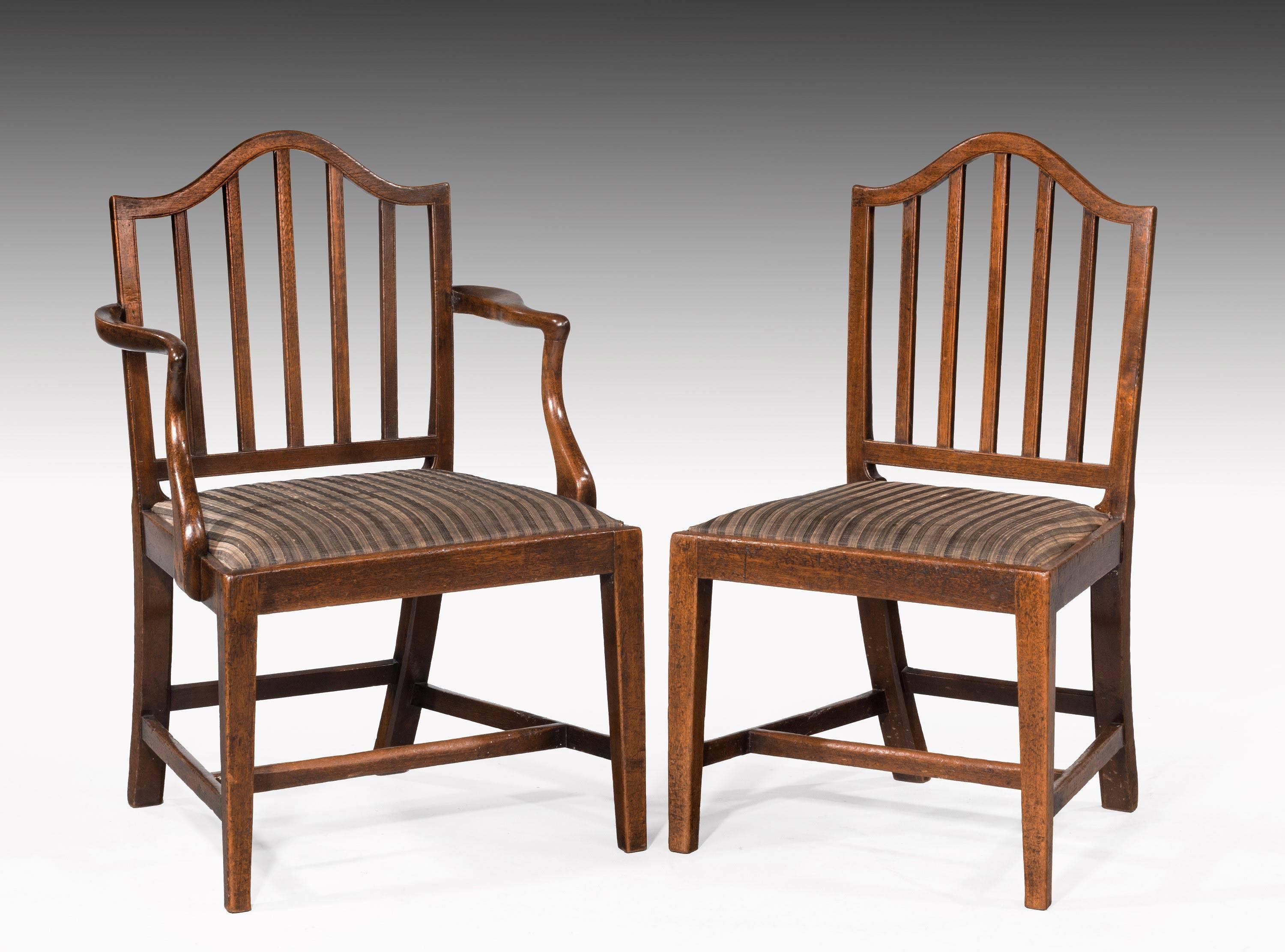 A set of ten (eight plus two) George III period mahogany chairs. In quite exceptional original and unrestored condition. The backs with a shaped serpentine top shoulder strap. The feet slightly tapering. Excellent overall color.

The armchairs -