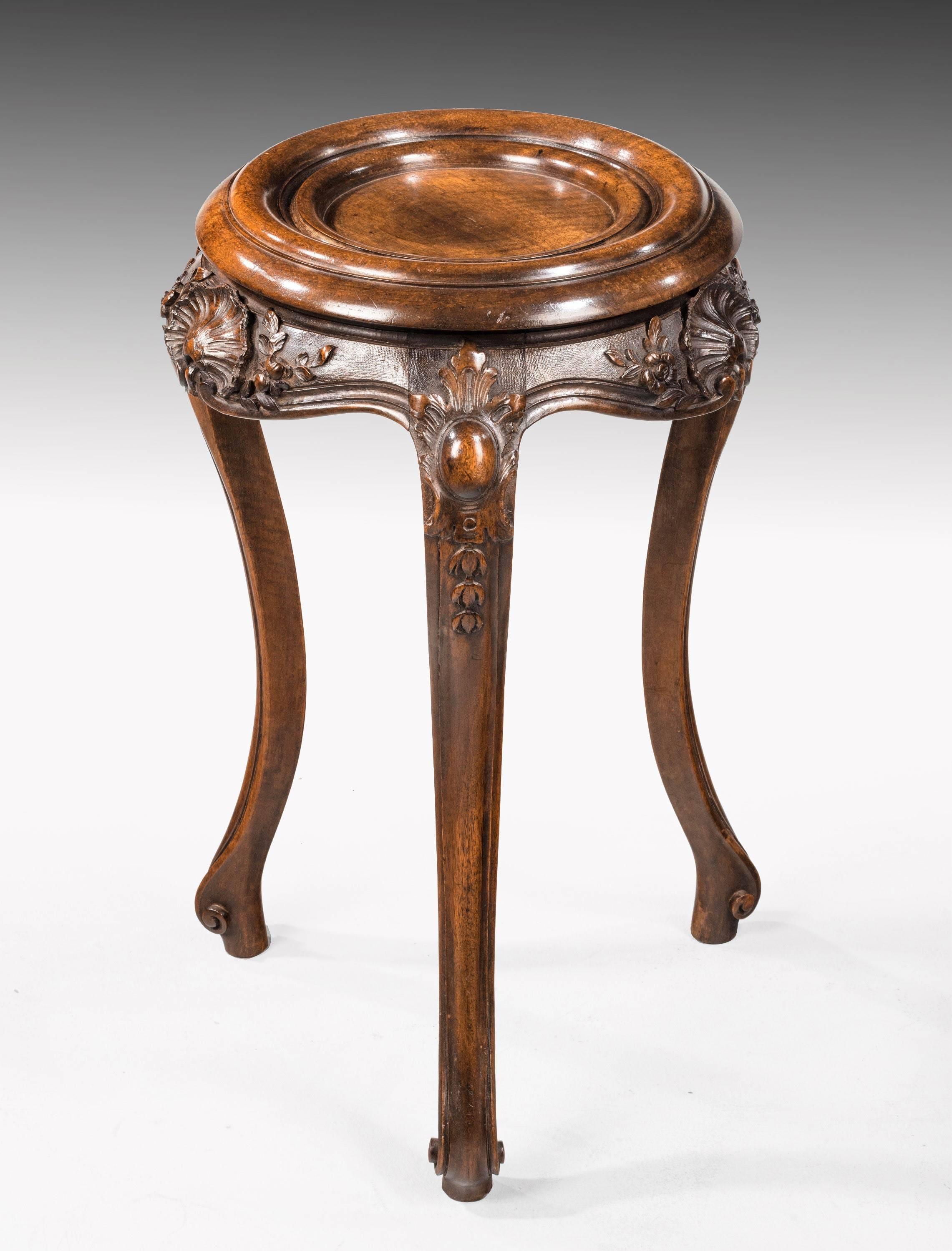 A finely carved pair of mid-19th century walnut bowl or vase stands. Very crisply defined shell details. Cabriole supports terminating in a semi scroll foot.