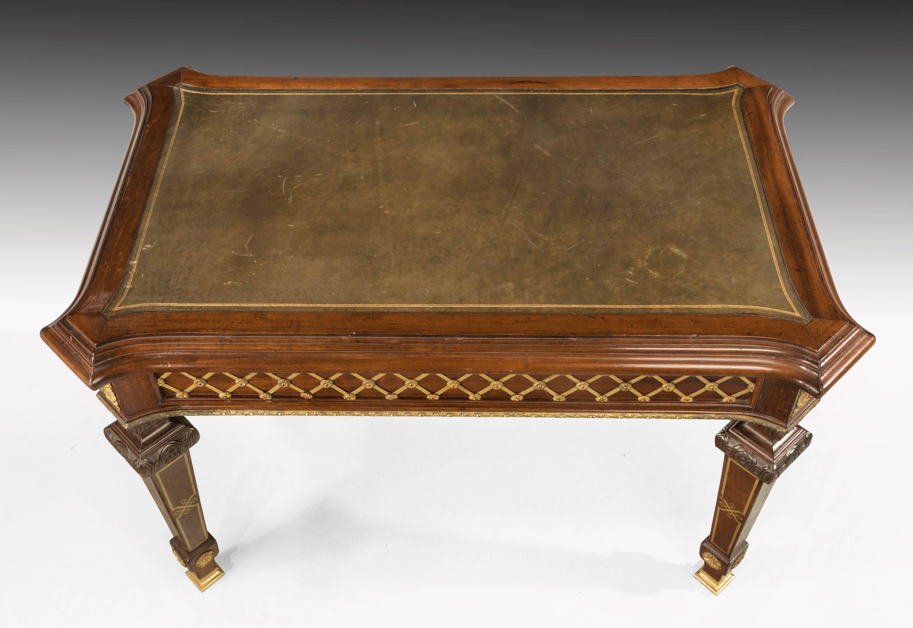 A most unusual pair of North European library tables in mahogany with inset leather tops. The whole forms finely decorated with cast gilt bronze mounts, retaining the original gilding. Square tapering supports with carved belts with finely inlaid