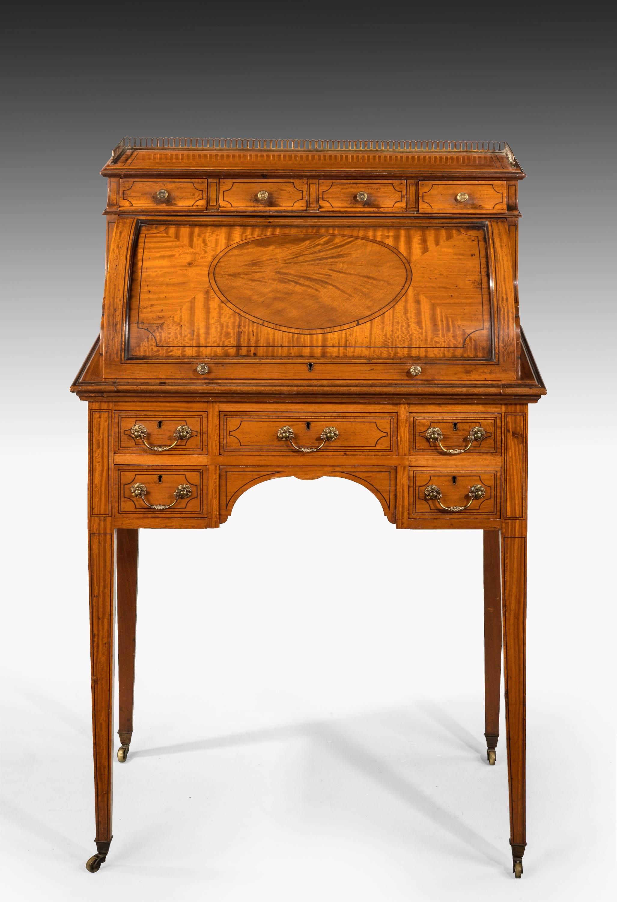 A good Edwardian period satinwood and mahogany ladies cylinder bureau on square tapering supports. Retaining the original cast swan neck handles. The interior fitted with shelves and Pidgeon holes.