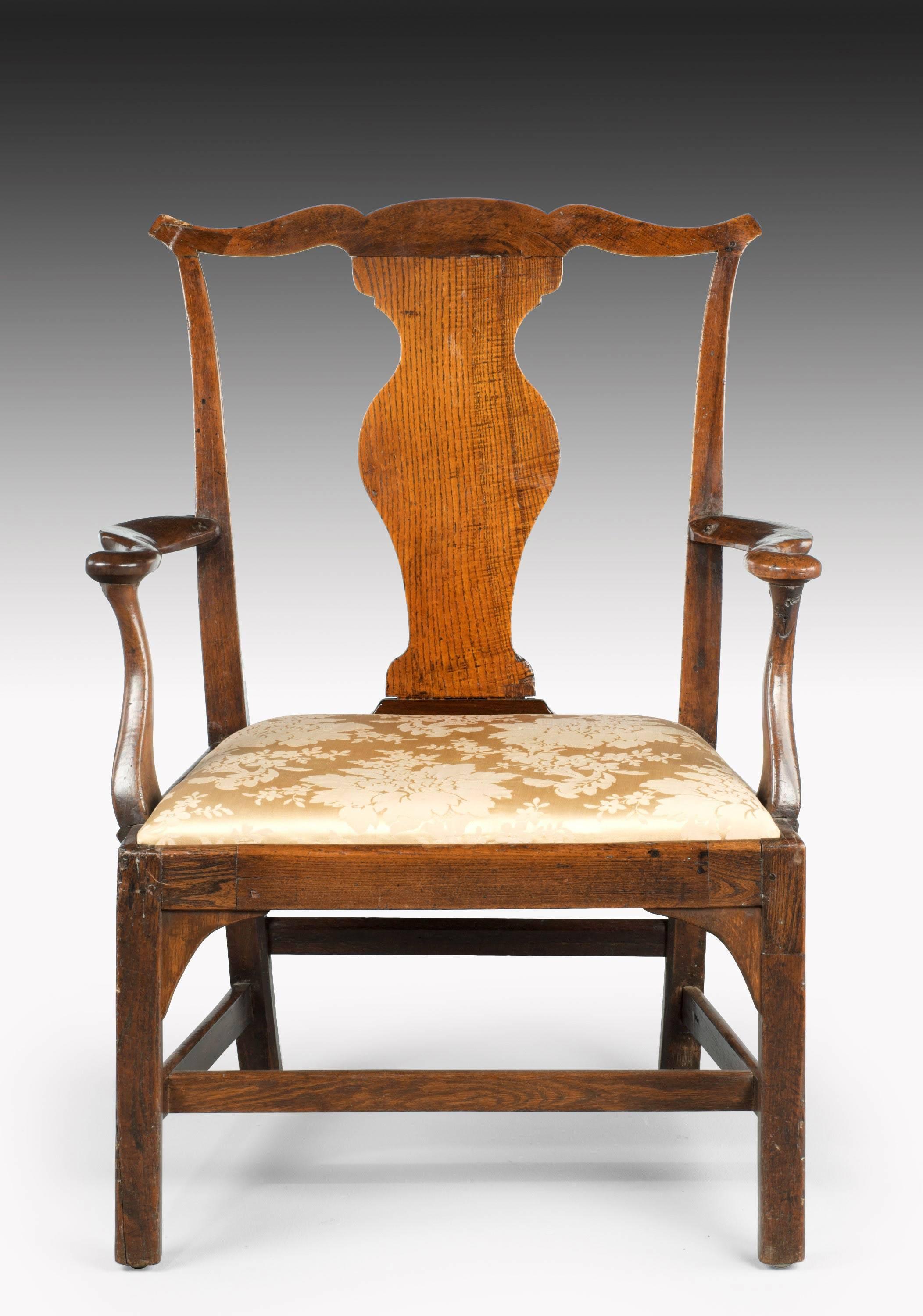 A good mid-18th century elbow chair of very substantial proportions. The wavy splat back beautifully figured under a serpentine top rail. Excellent flaring and shaping to the serpentine supports. 

Seat height 18 inches.