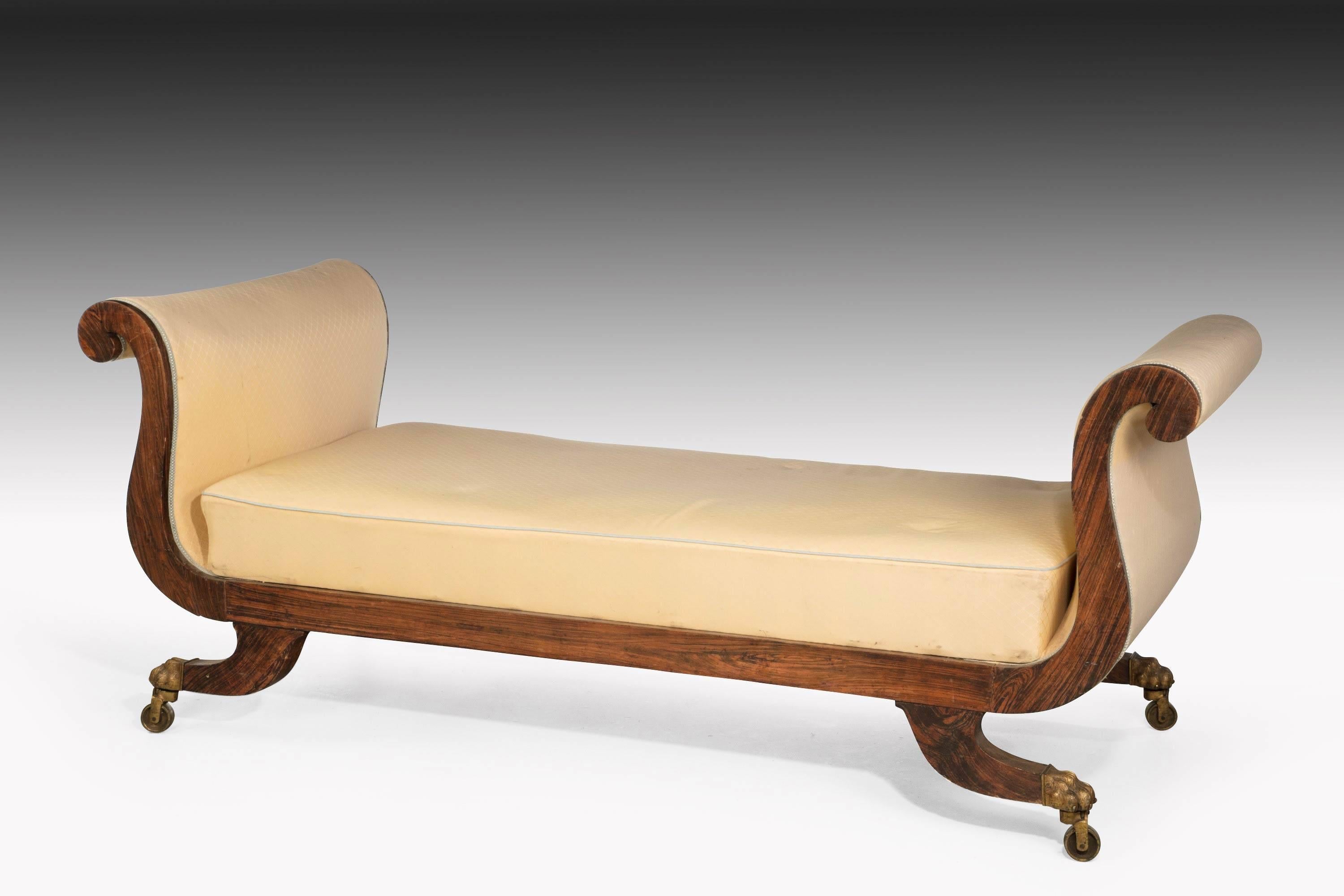 An unusually large Regency period end support sofa with elegant swan neck uprights. The sabre legs retaining the original shoes and castors. Very well figured and excellent overall condition.