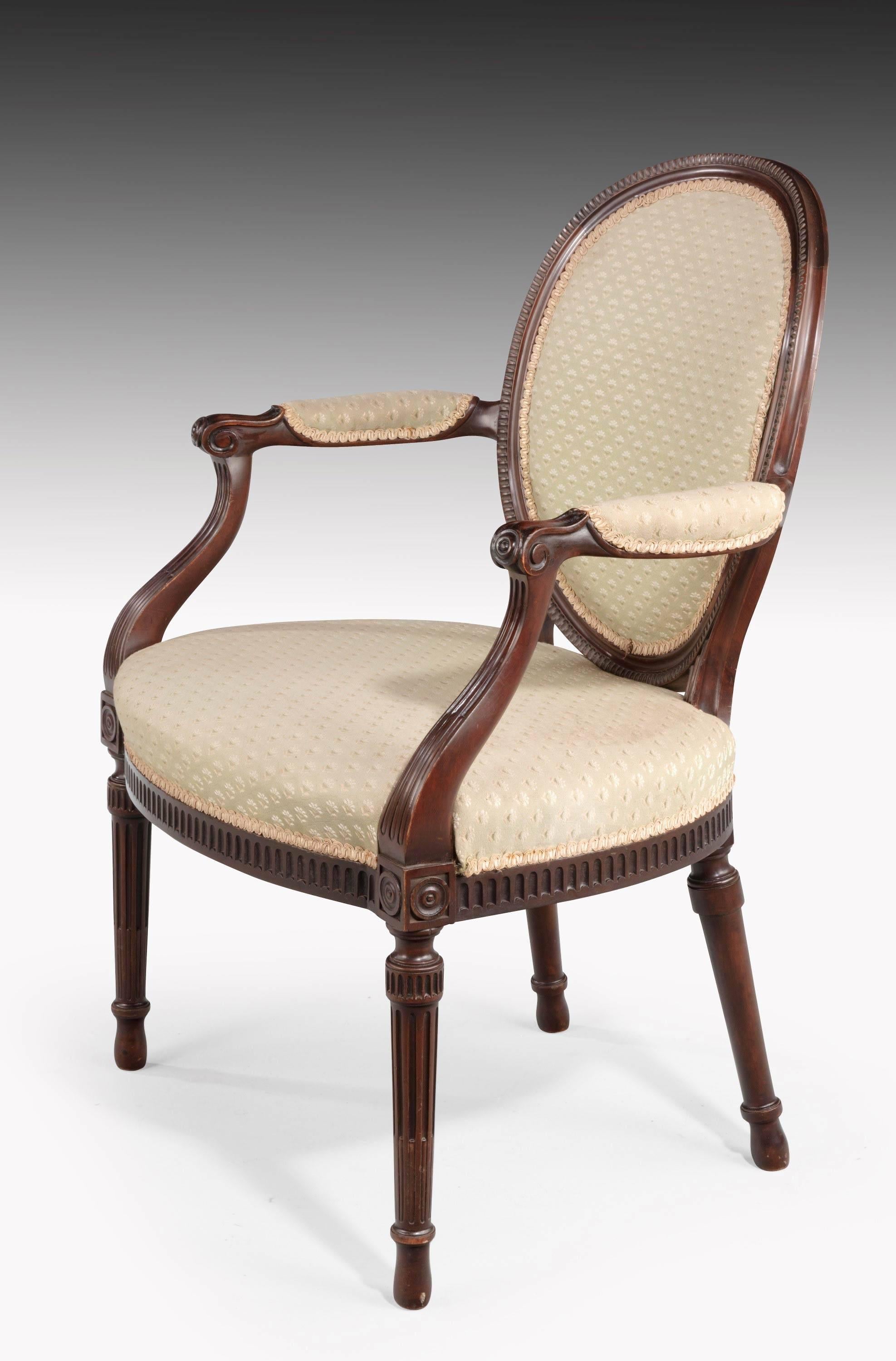 A pair of George III style Hepplewhite elbow chairs. The front rail with reeded incised decoration, the arms similarly carved. Very good overall condition. 

Measures: Seat height 17.5 inches.