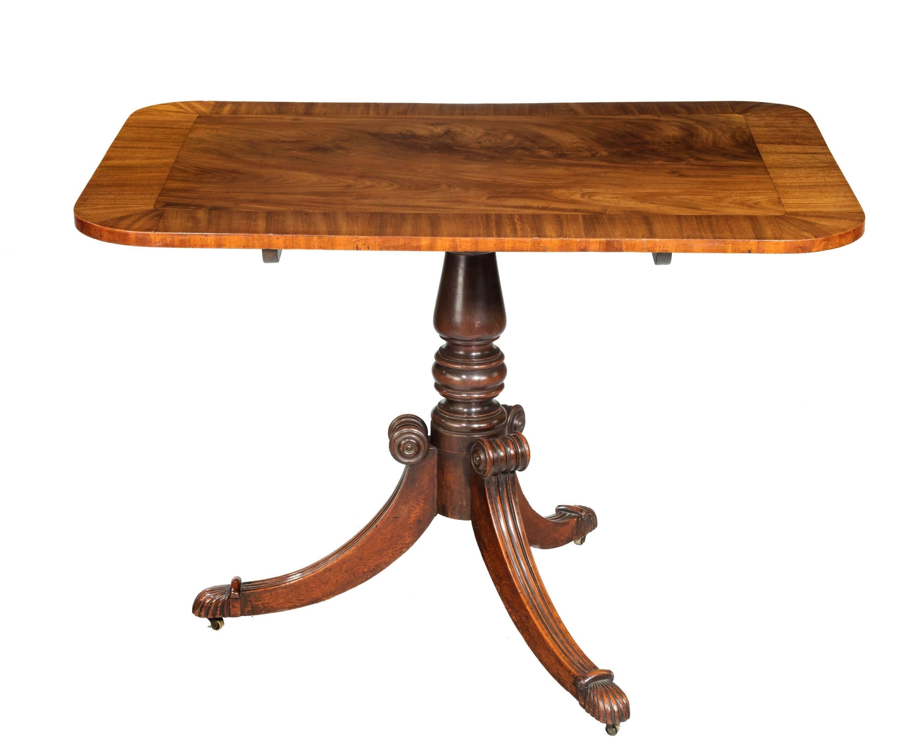 A particularly beautifully figured George III period mahogany small breakfast table. The top with large crossbanded edging. On a turned central support with reeded sabre legs. Excellent overall condition.