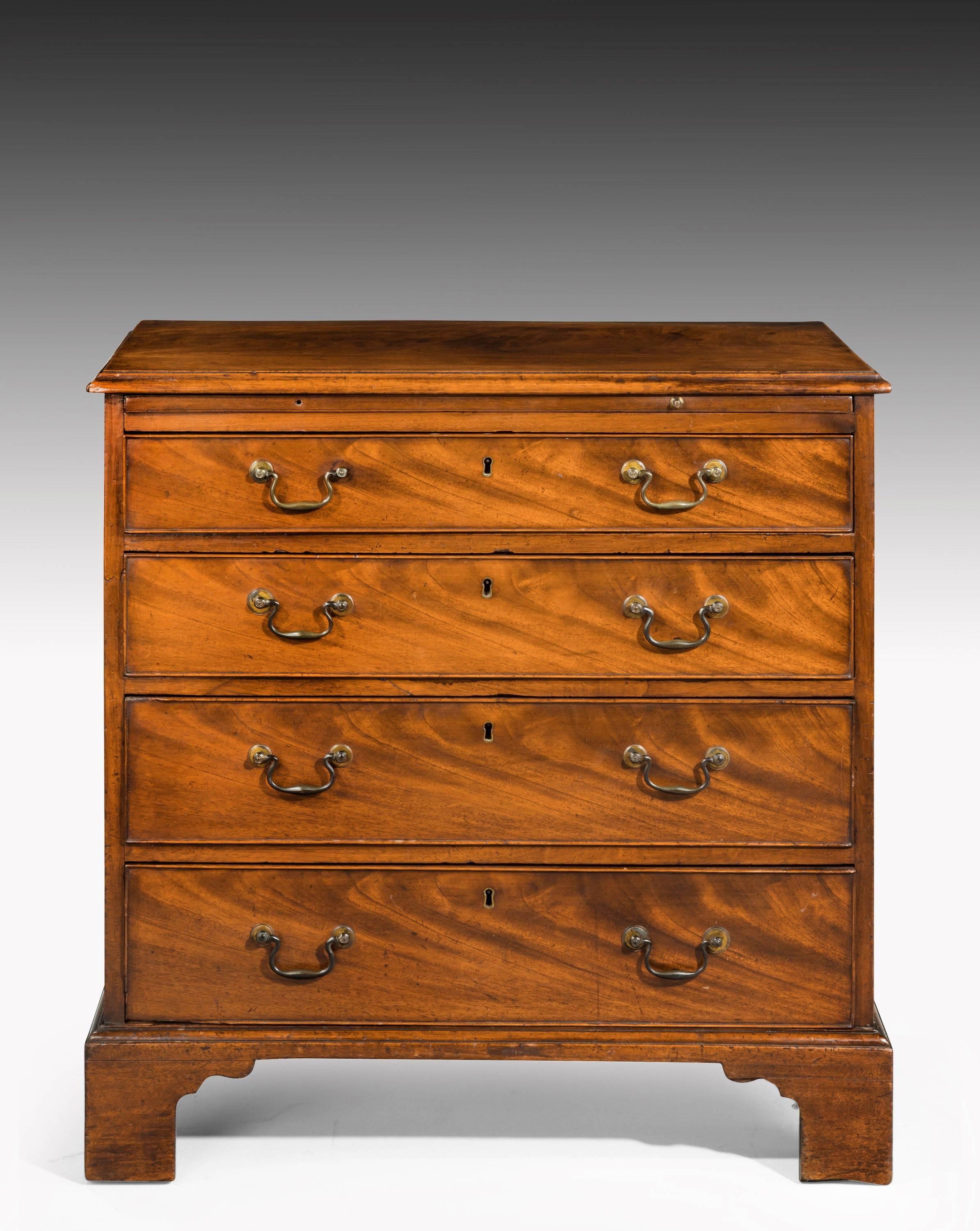 A good George III period mahogany chest of small proportions. The top section with a brushing slide. Original swan necked handles and bracket feet.