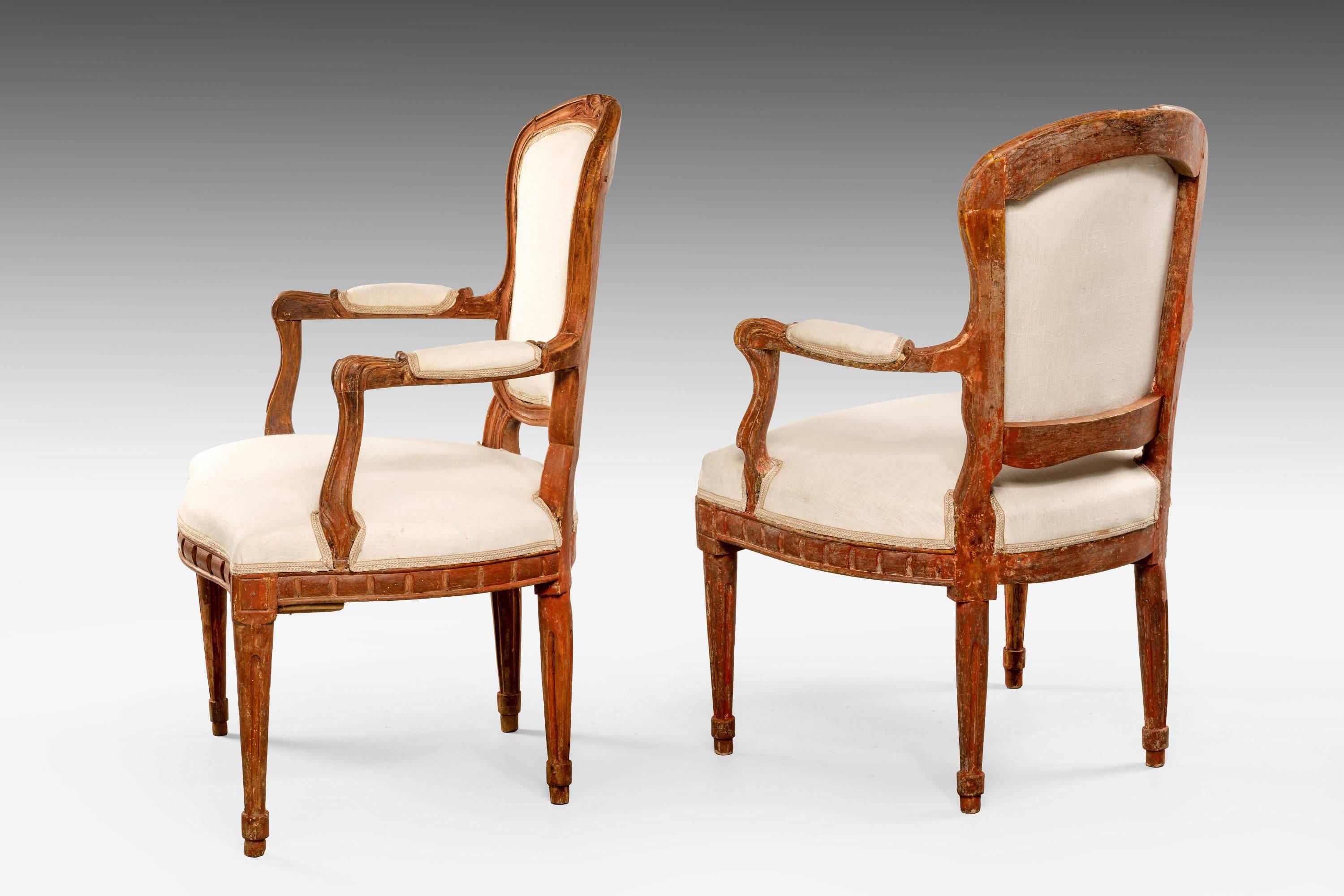 A pair of 18th century beech Louis XVI chairs. The serpentine front rail with unusual rectangular section carving, the whole now somewhat tired. RR.