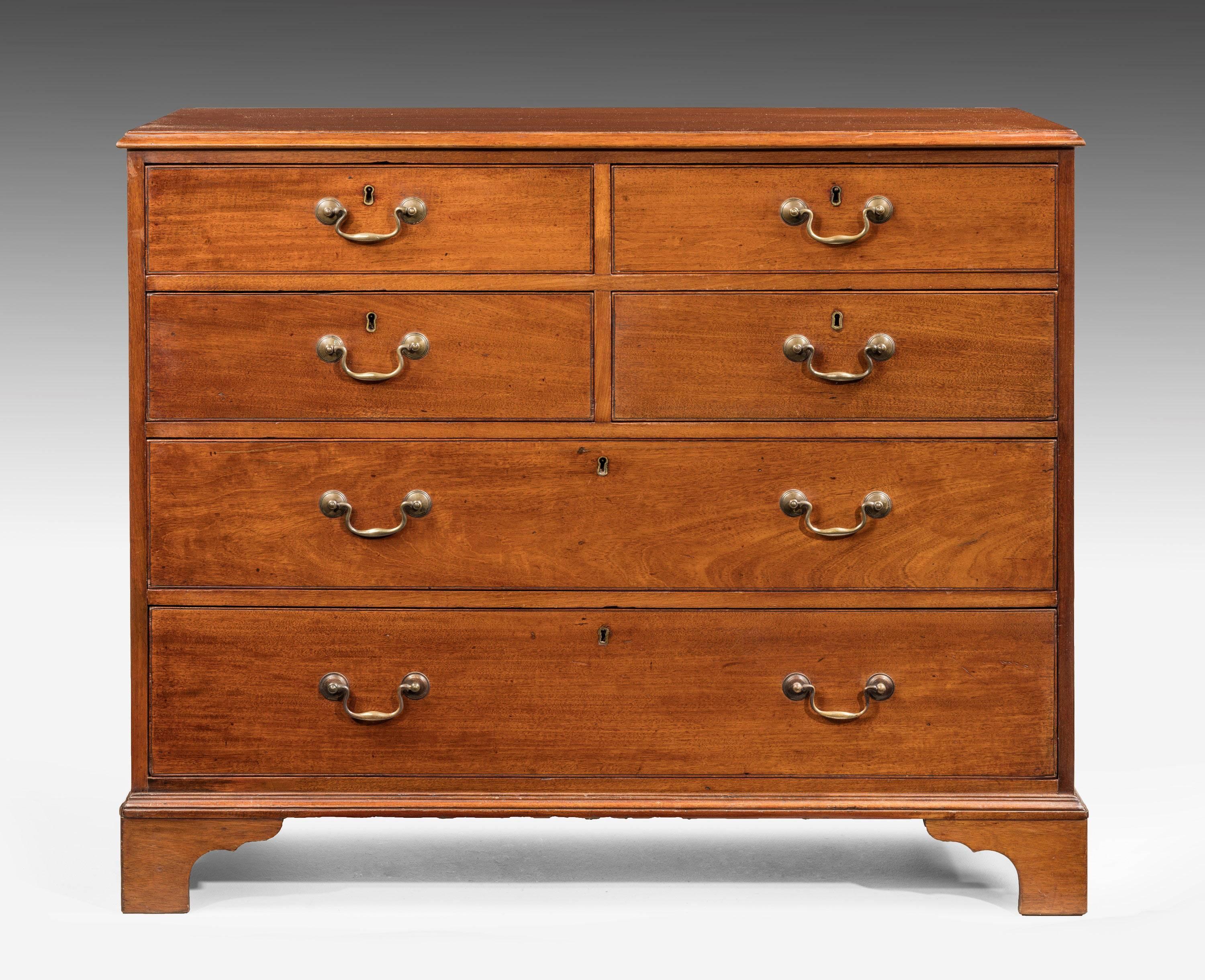 A George III mahogany chest of drawers. With fine and original cast neck handles. Retaining the original bracket feet.
             