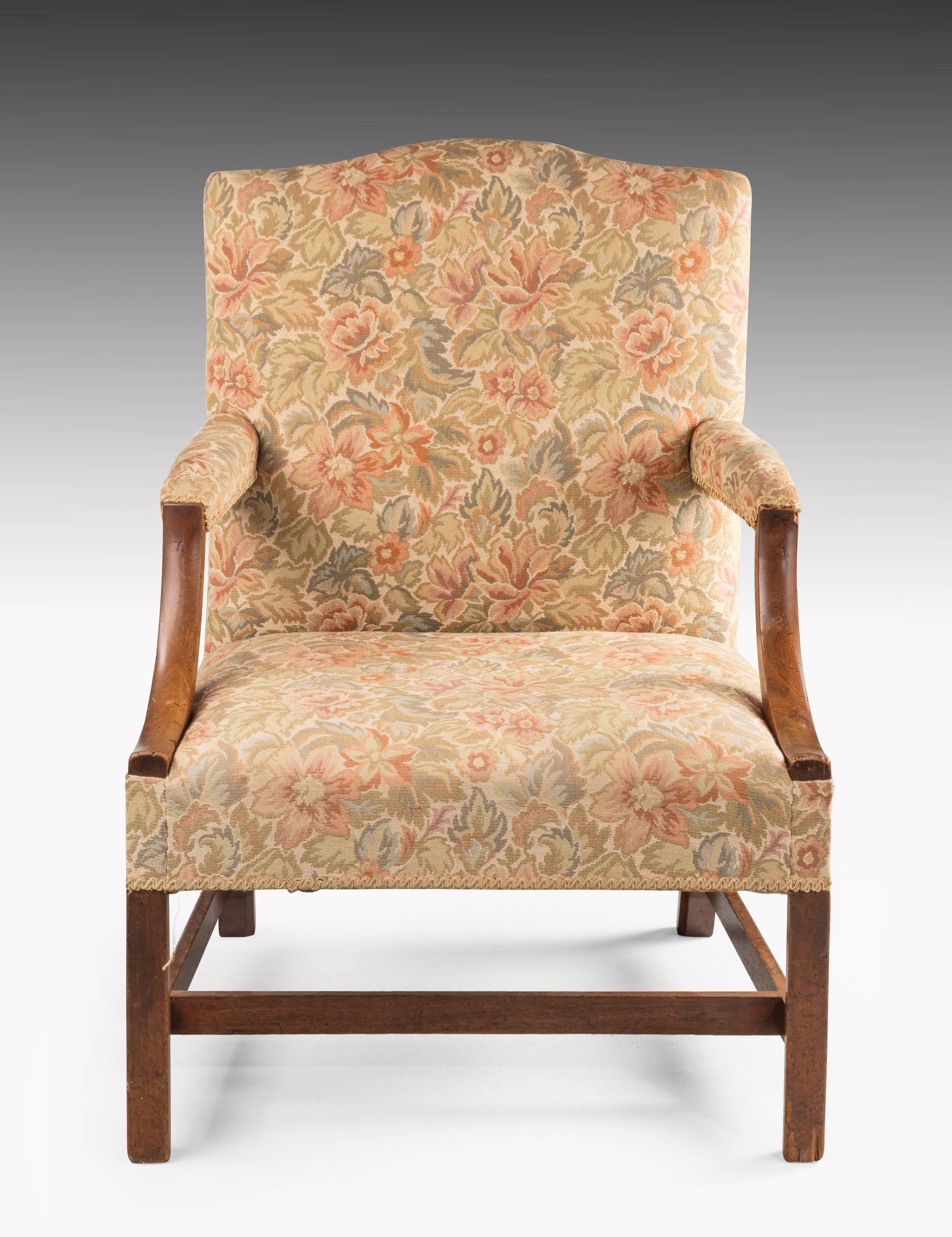 George III period mahogany Gainsborough armchair with strong square supports joined by an H stretcher. Swept arms of very good color and patina.

Seat height 18 inches.