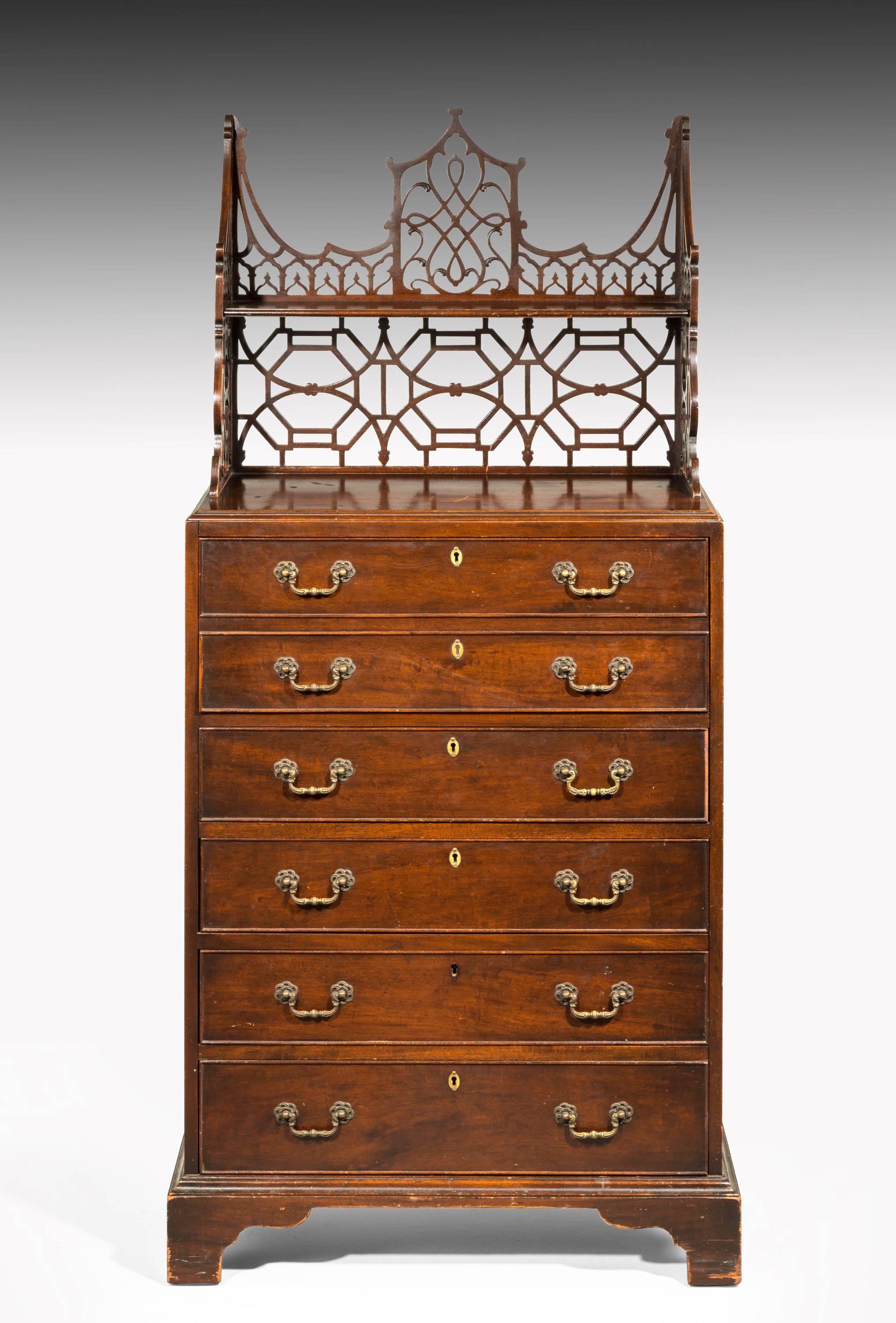 A most attractive Chippendale design mahogany chest of drawers with the original upper fretwork bookshelves. Shaped bracket feet. Good original brass handles. The design circa 1765-1770 but the actual piece, circa 1910.