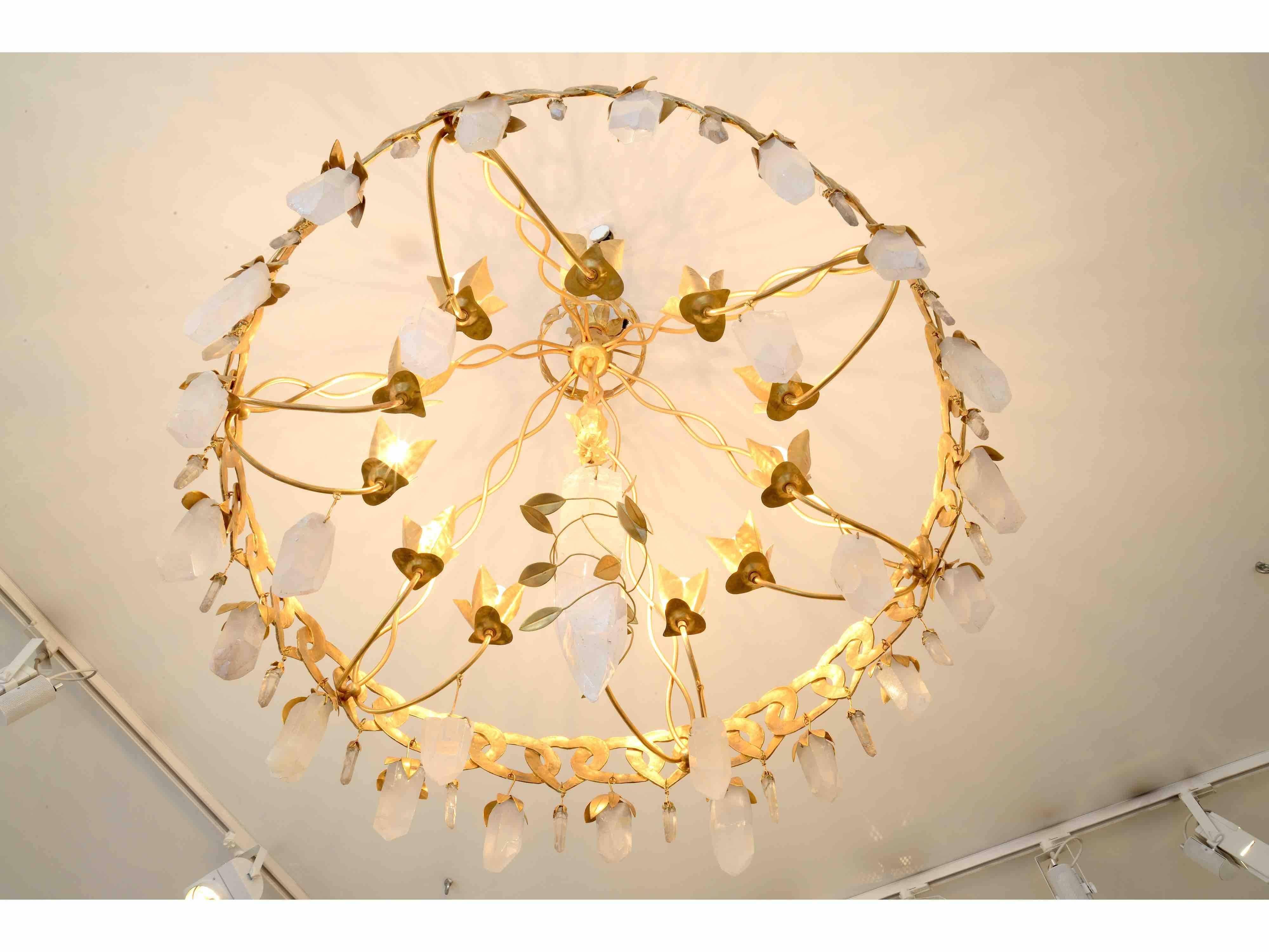 Refined chandelier in gilt bronze with rock crystal drops by Robert Goossens (Paris, 1927-2016). 
Signed twice on the rings and with a 
