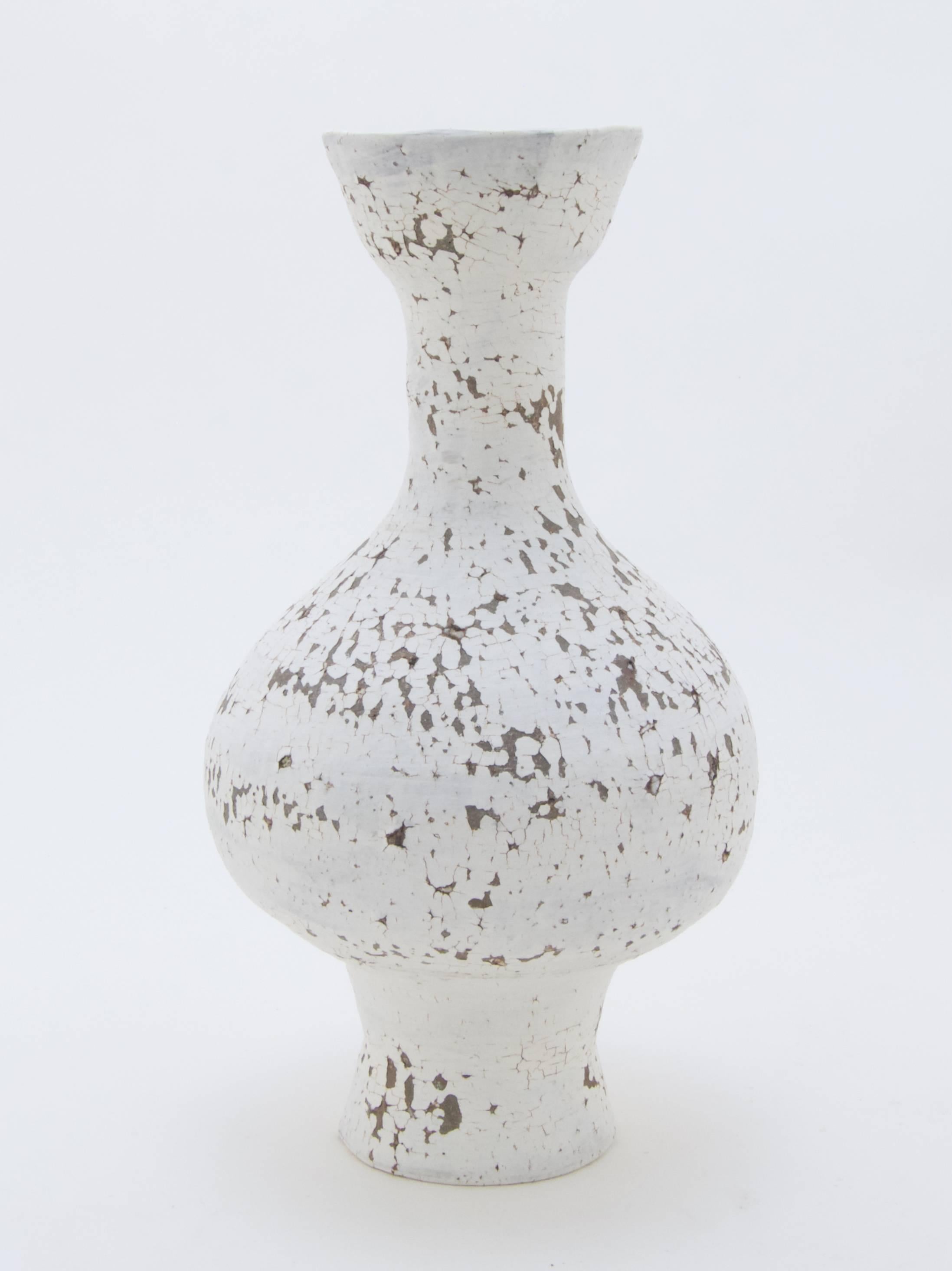 Flower vase by Austrian ceramic artist Matthias Kaiser.
The shape has been wheel thrown from a Czech stoneware clay and treated with white slip, similar to the Japanese/Korean Hakeme and Kohiki styles.
But the piece underwent two high-temperature