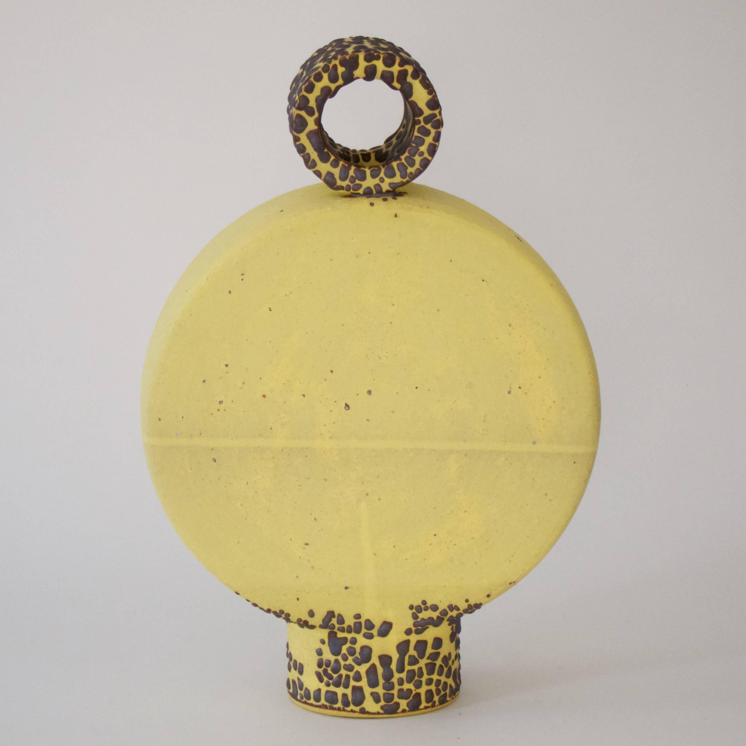 A stoneware ceramic vase by Matthias Kaiser.
The body of the vase is a flat disc, made from two large trays that have been joined at the rims.
It is supported by an oval foot ring. The shape corresponds to that of traditional pilgrim flasks,
but is