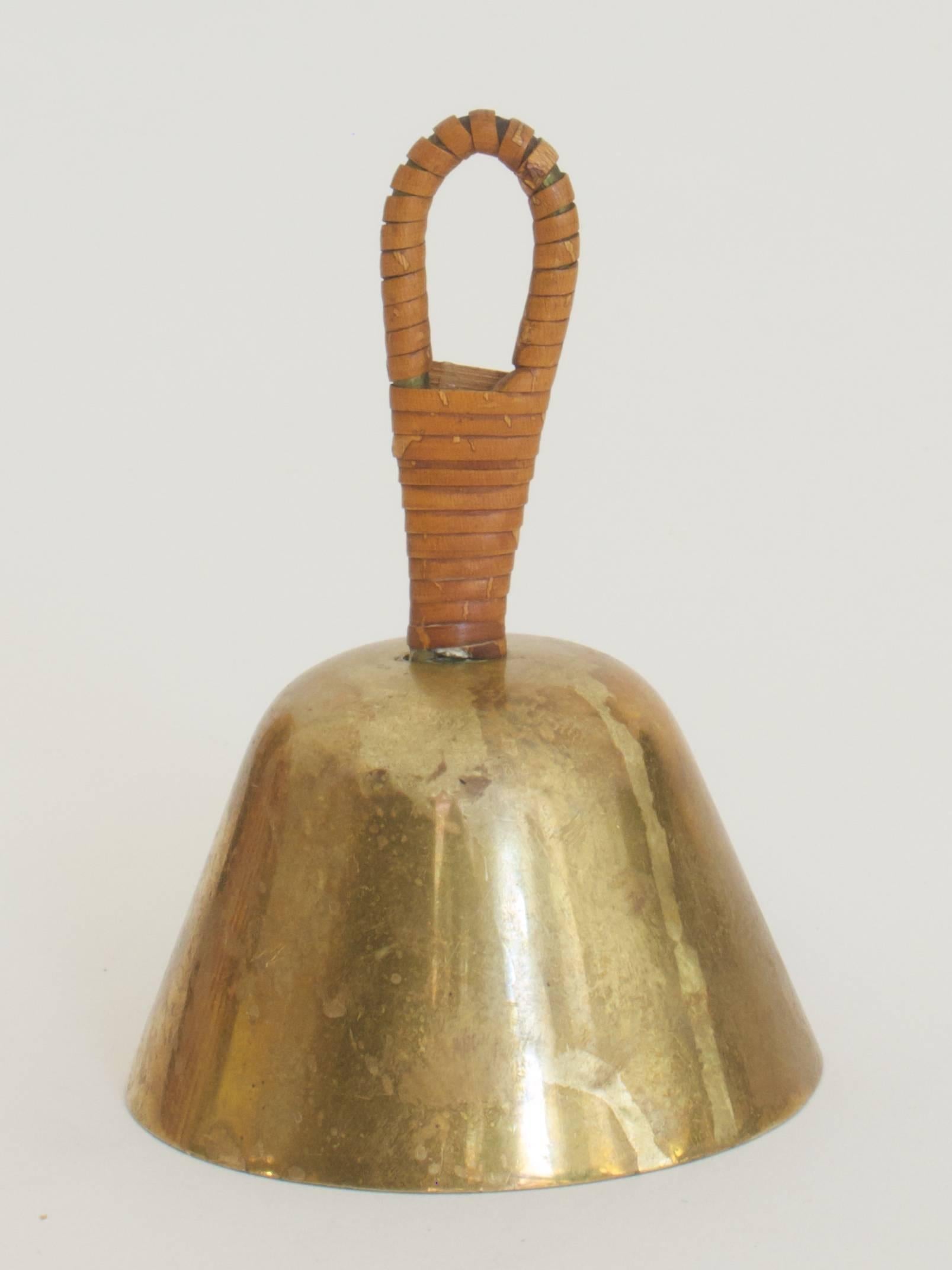 Bell by Carl Auböck
polished brass, inside patinated
handle coiled up with wicker.