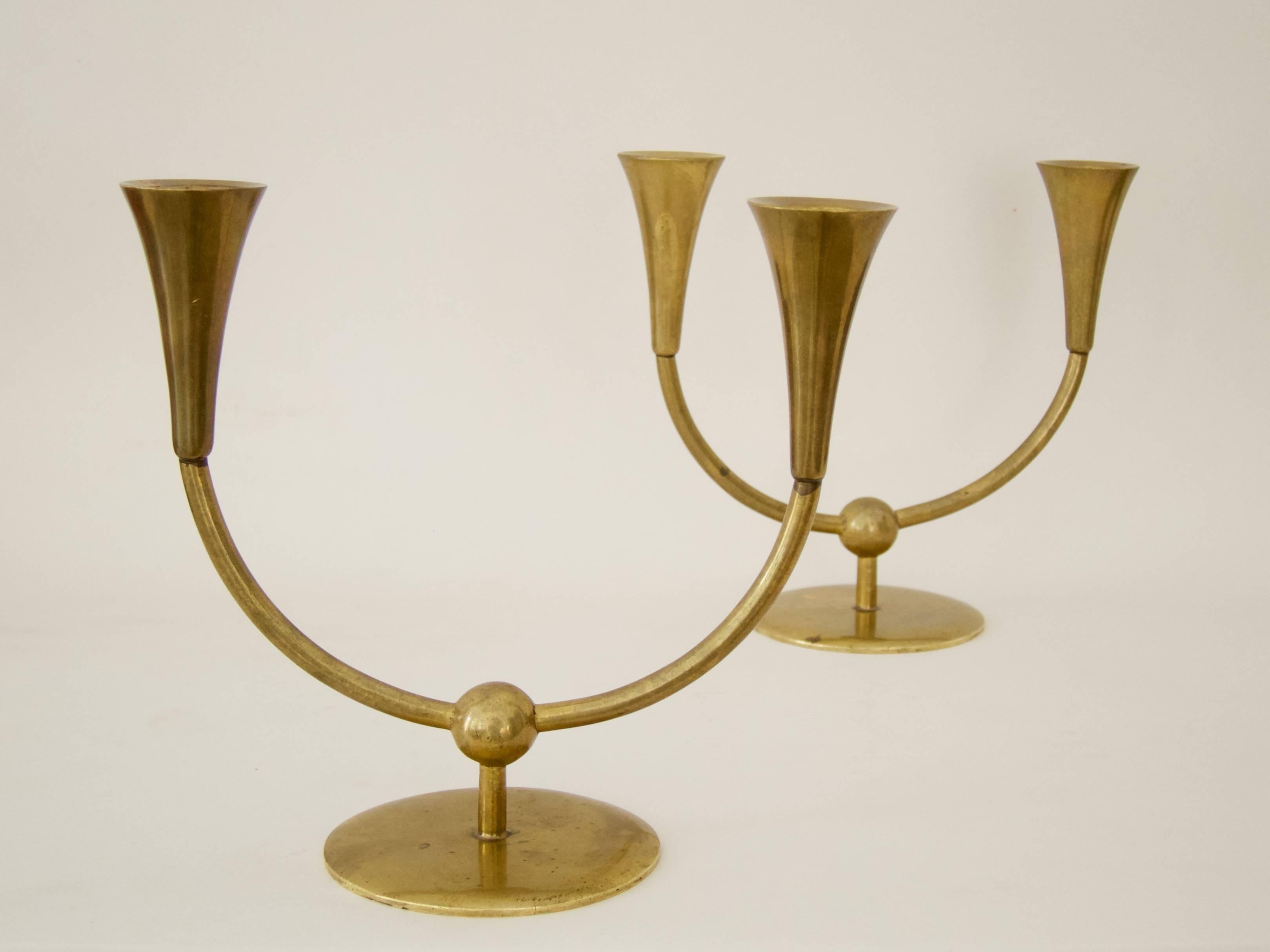 A pair of two-arm candeholders designed by the former head-workman of the Werkstätte Hagenauer, Richard Rohac.

The model numbers: 213 and 216 are engraved at the bottom of both candleholders.