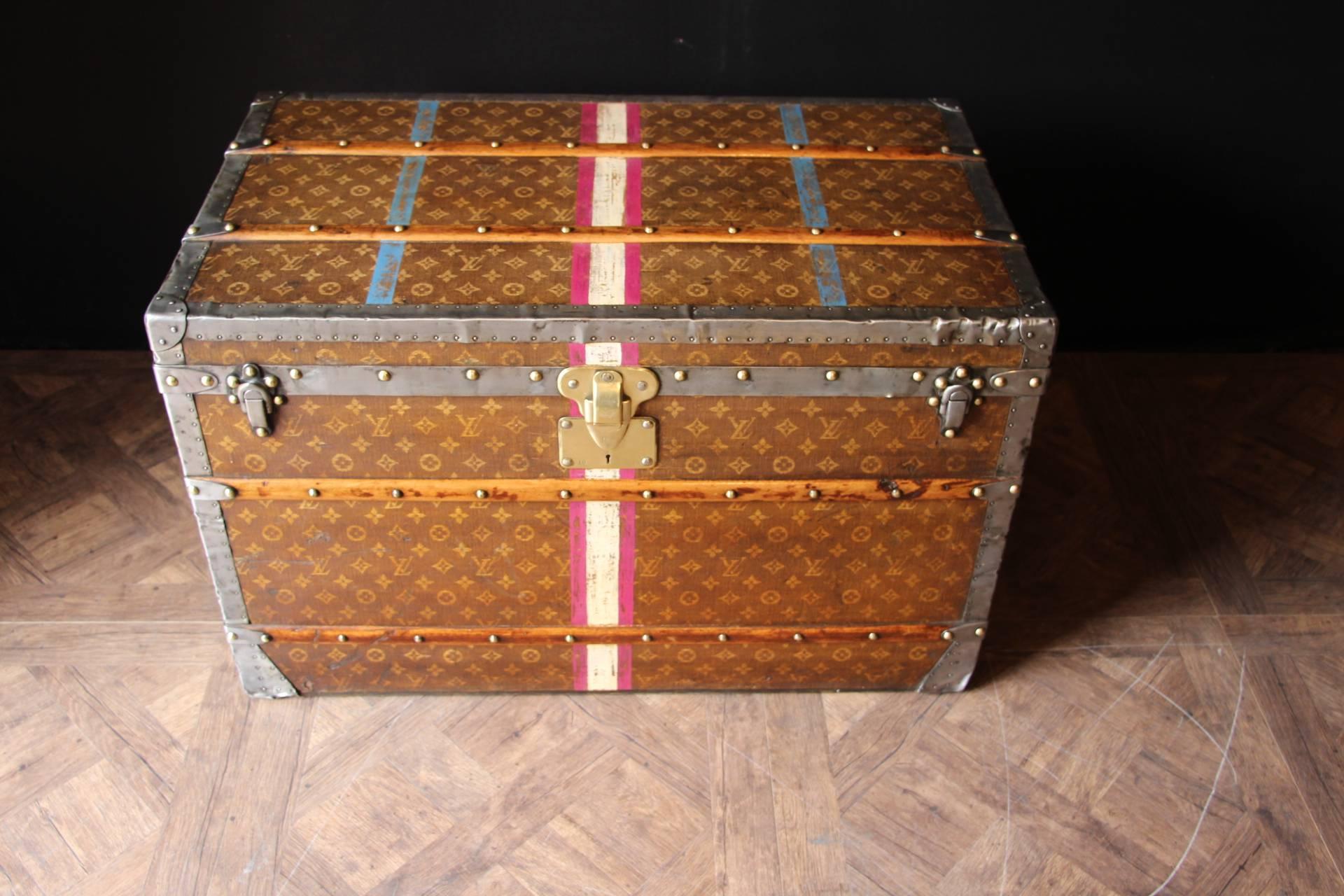 This is a superb Louis Vuitton steamer trunk, large size, rare and sought after Tisse' monogram canvas, metal bound with brass studs, reinforced with wooden laths,  wheels to the base and metal handles to either end, interior lined with cream