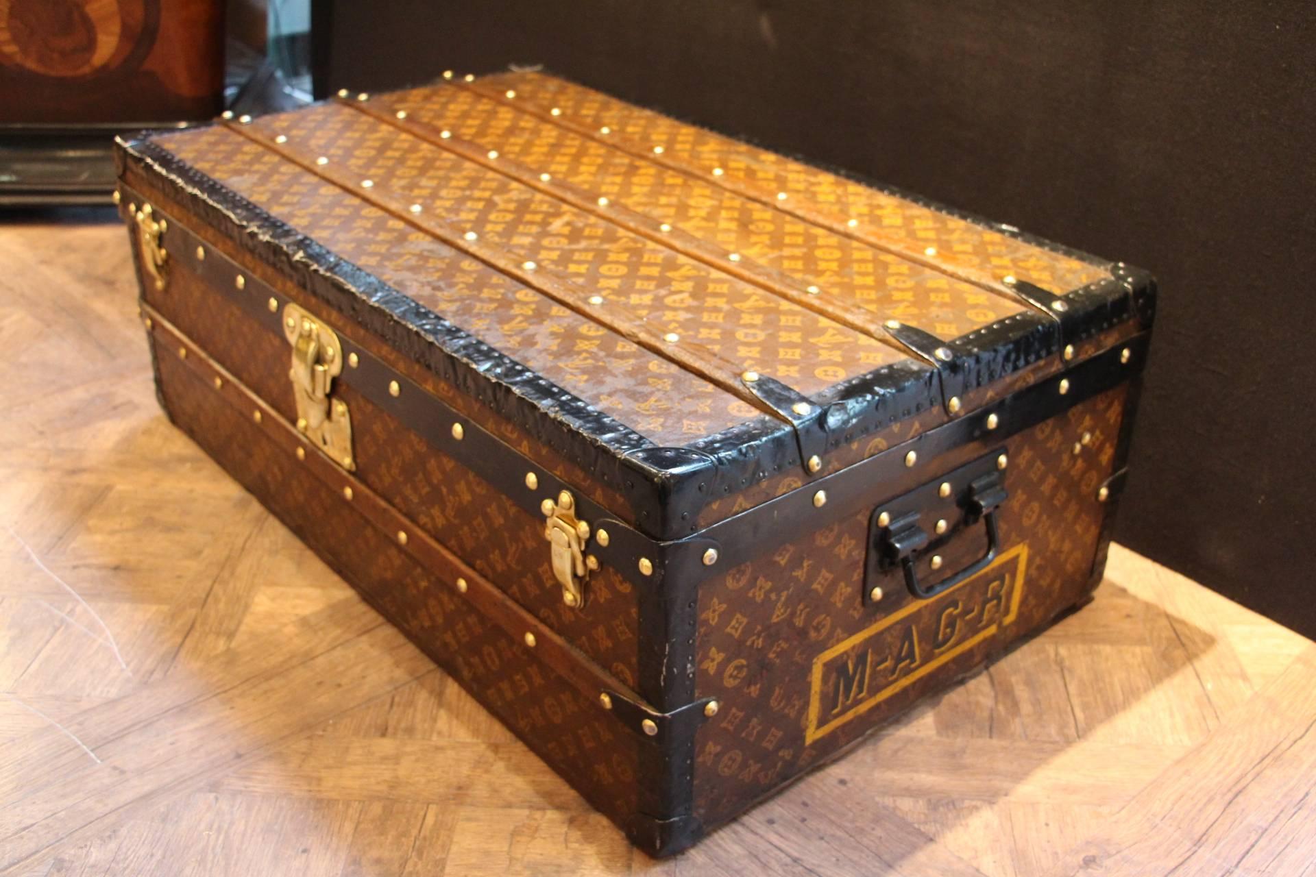Louis Vuitton steamer trunk featuring stenciled monogram canvas, steel trim and side handles, Brass clasps, lock and stamped studs. Superb warm patina.
Its interior has been perfectly relined a while ago exactly like the original used to be. Clean