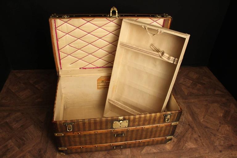 This magnificent striped steamer trunk from the Louis Vuitton brand mixes  solid brass and leather
