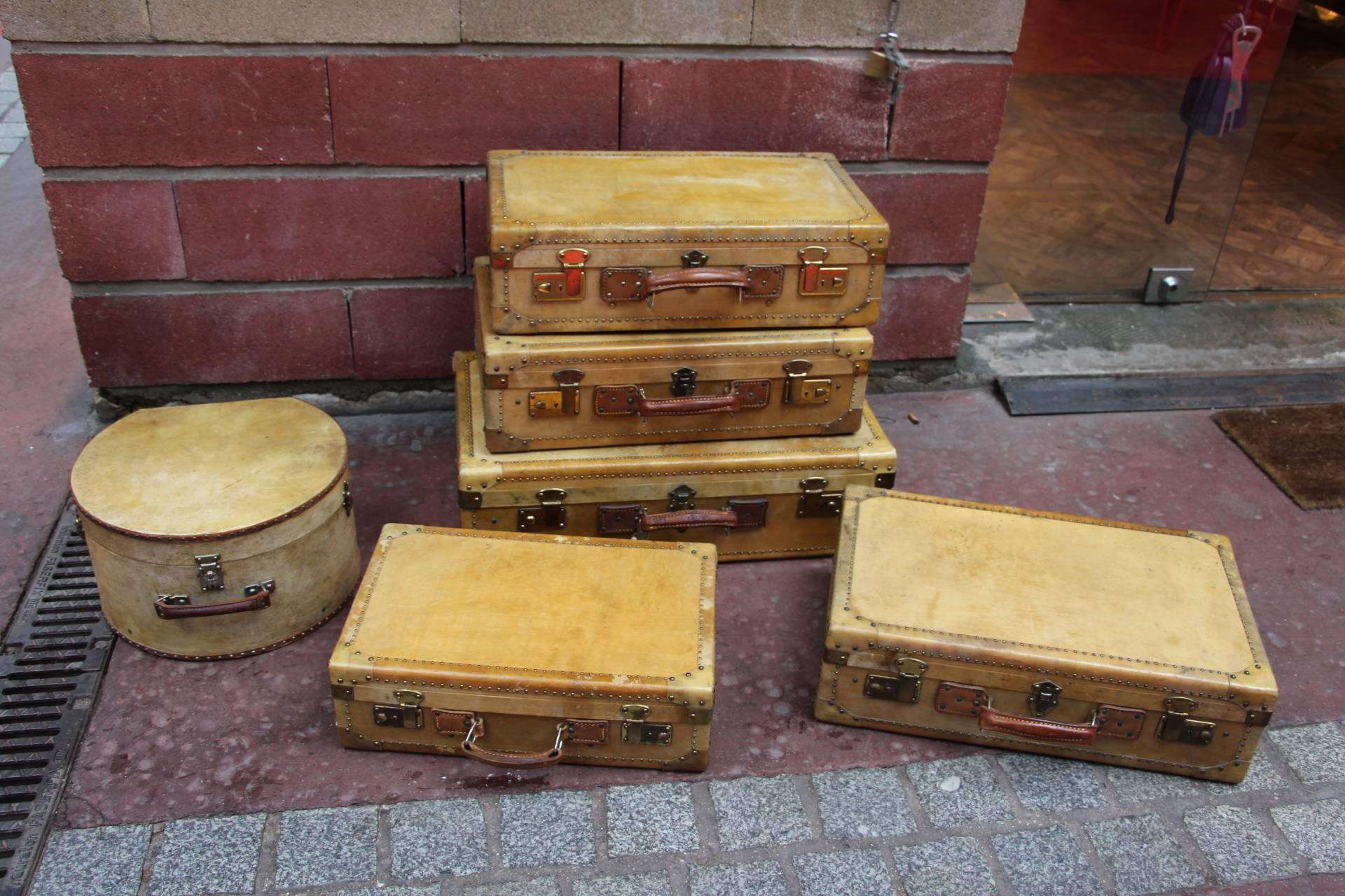 French Set of Vellum Pieces of Luggage, Five Vellum Suitcases and One Round Hat Box