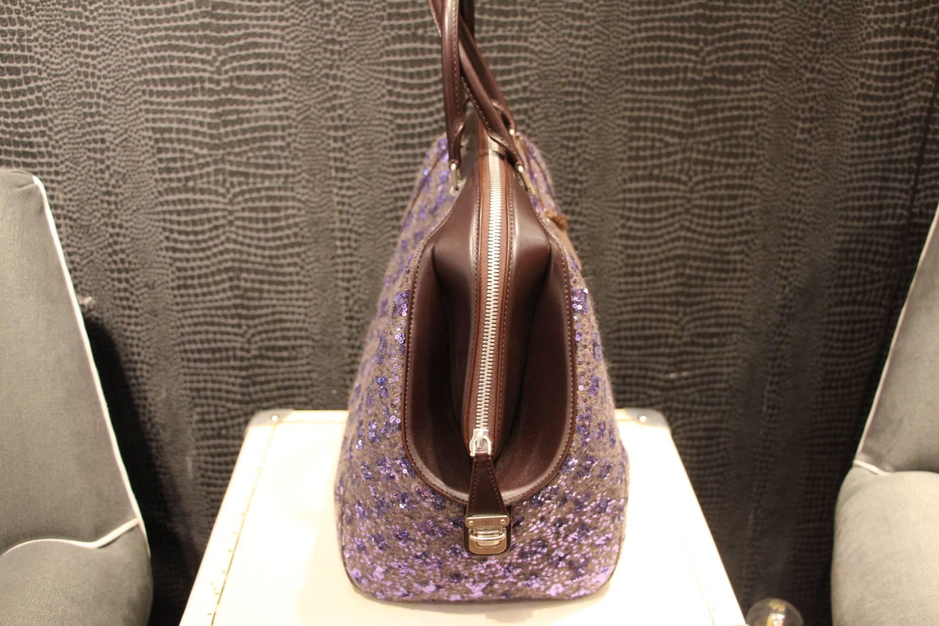 This beautiful bag is from the 2012-2013 fall/winter runway collection. It has got unusual shape and features luxurious leather, a multitude of luminous purple sequins painstakingly embroidered on for a truly dazzling effect and a luminous LV
