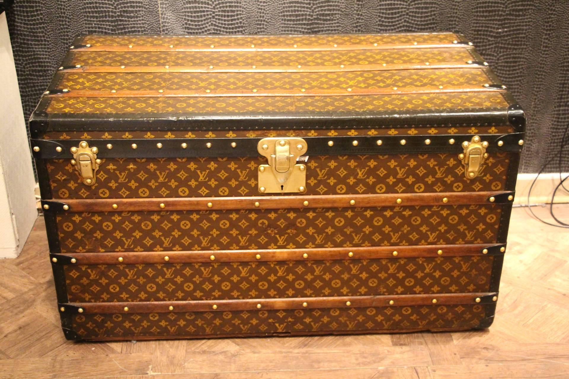 This Louis Vuitton trunk features stenciled canvas, black lozine trim, black steel side handles, Louis Vuitton stamped brass locks as well as Louis Vuitton stamped brass studs. Very nice patina.
Its interior is all original too and it is fitted