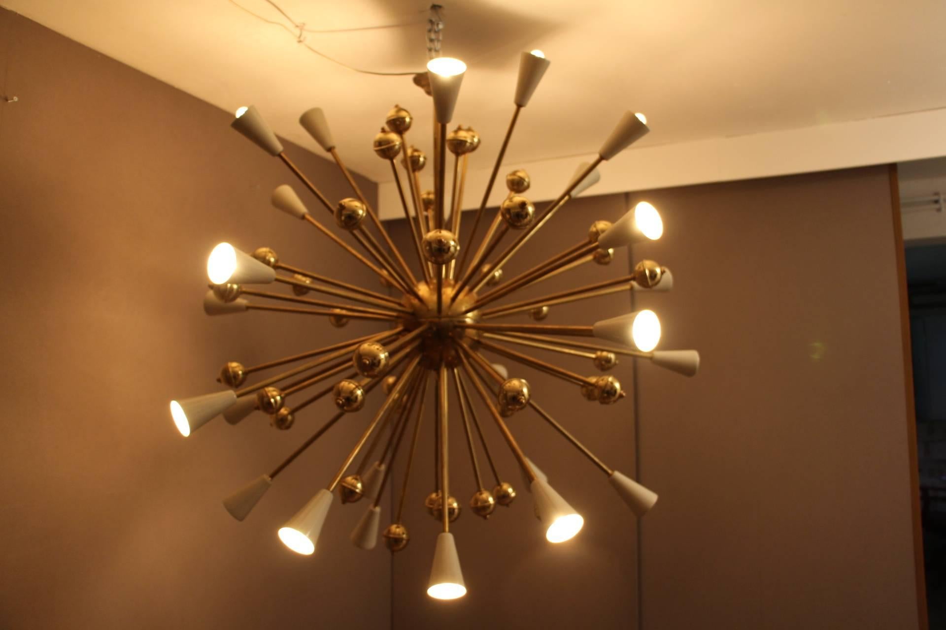 Very elegant Sputnik brass chandelier featuring 26 lights and 40 rods ending with brass bowls. White lacquered steel cones.
 