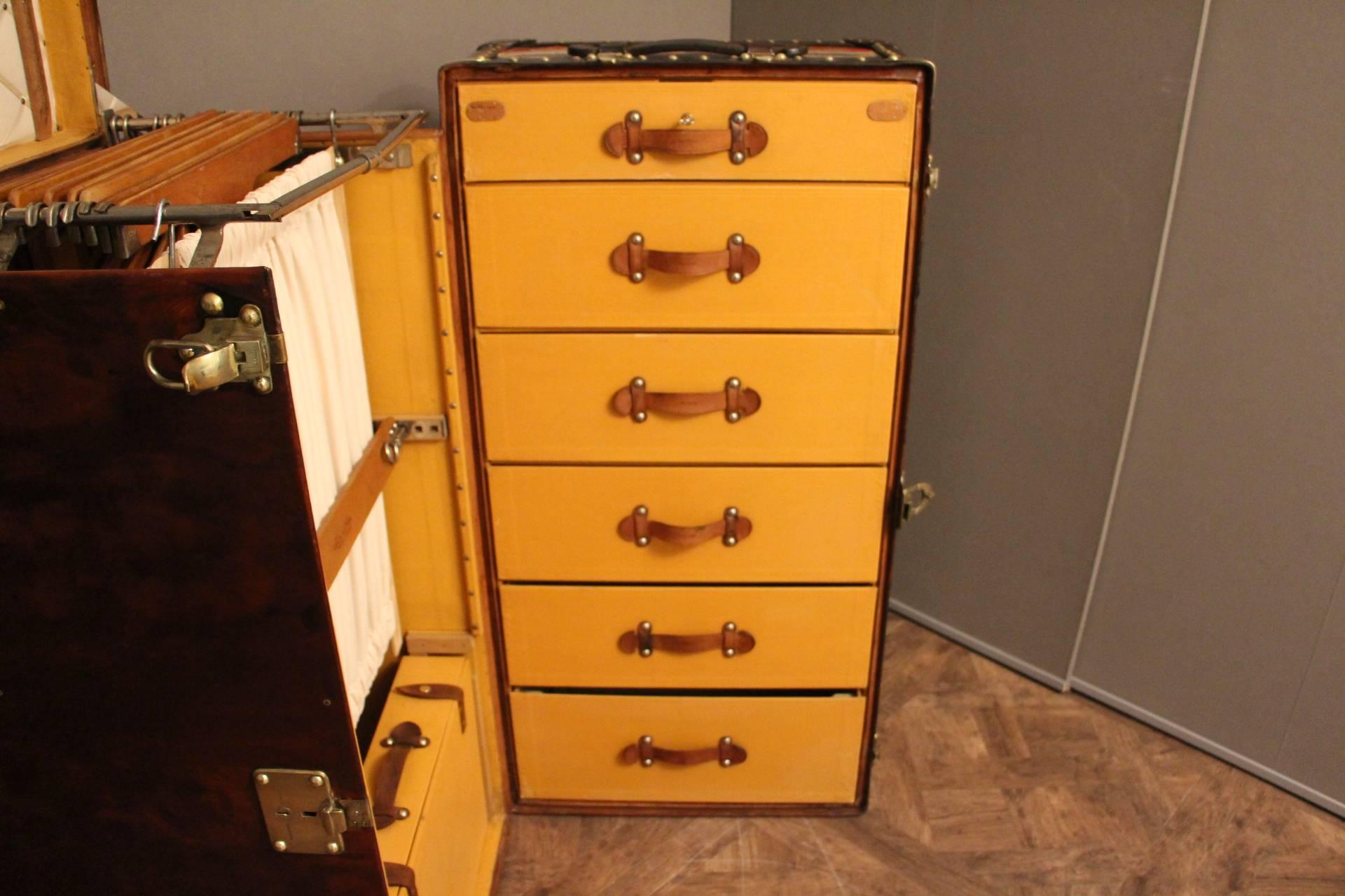This very rare Louis Vuitton trunk features a rich and very warm brown leather shaded patina. It features a lift top, stamped Louis Vuitton brass studs, lock and latches. Original leather handle on the top as well as many travel tags.
Once open, it