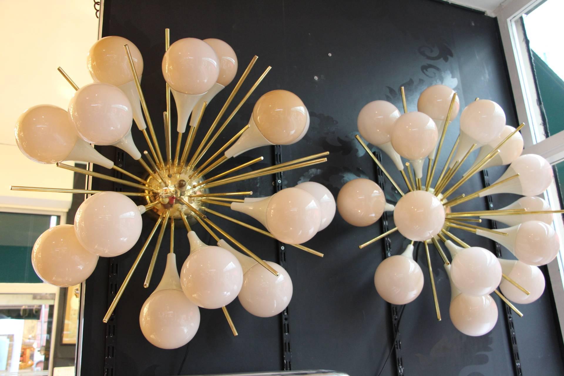 This fabulous pair of sconces features 15 pinkish-beige Murano glass globes and 15 brass stems.
It looks like large flowers and is really breath taking.
When light is on, its very light pink-beige globes turn to beige color.
Thanks to their very