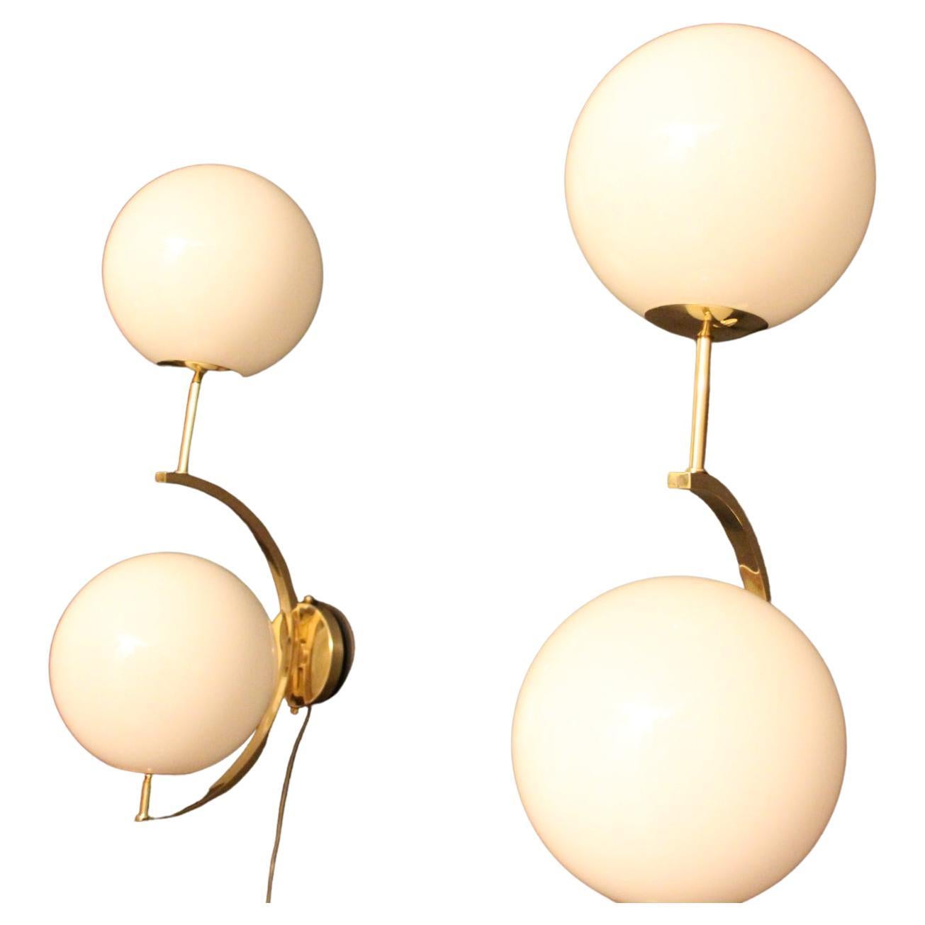 These sconces are very elegant with their brass frame and white Murano glass globes. They have got very unusual geometrical proportions and are very elegant.
Take E14 bulbs. Wired for U.S.
Each sconce is 3 kg.
Globes are approximately 15 cm