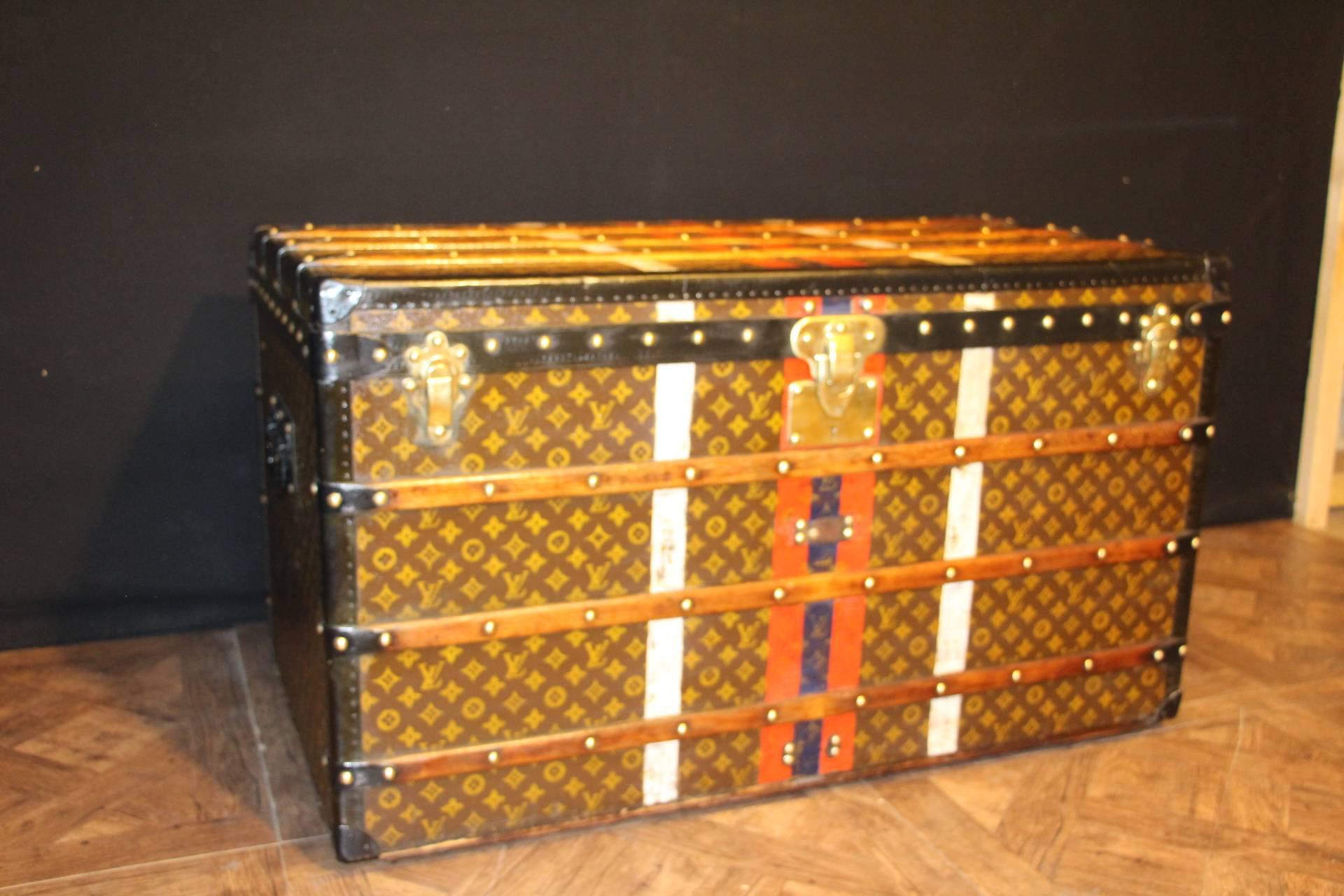 This beautiful Louis Vuitton trunk is all stenciled LV monogram canvas, with all brass hardware and black lozine trim. It has got a remarkable patina. Blue, white and red identity stripes.
All original beige linen interior with one large removable